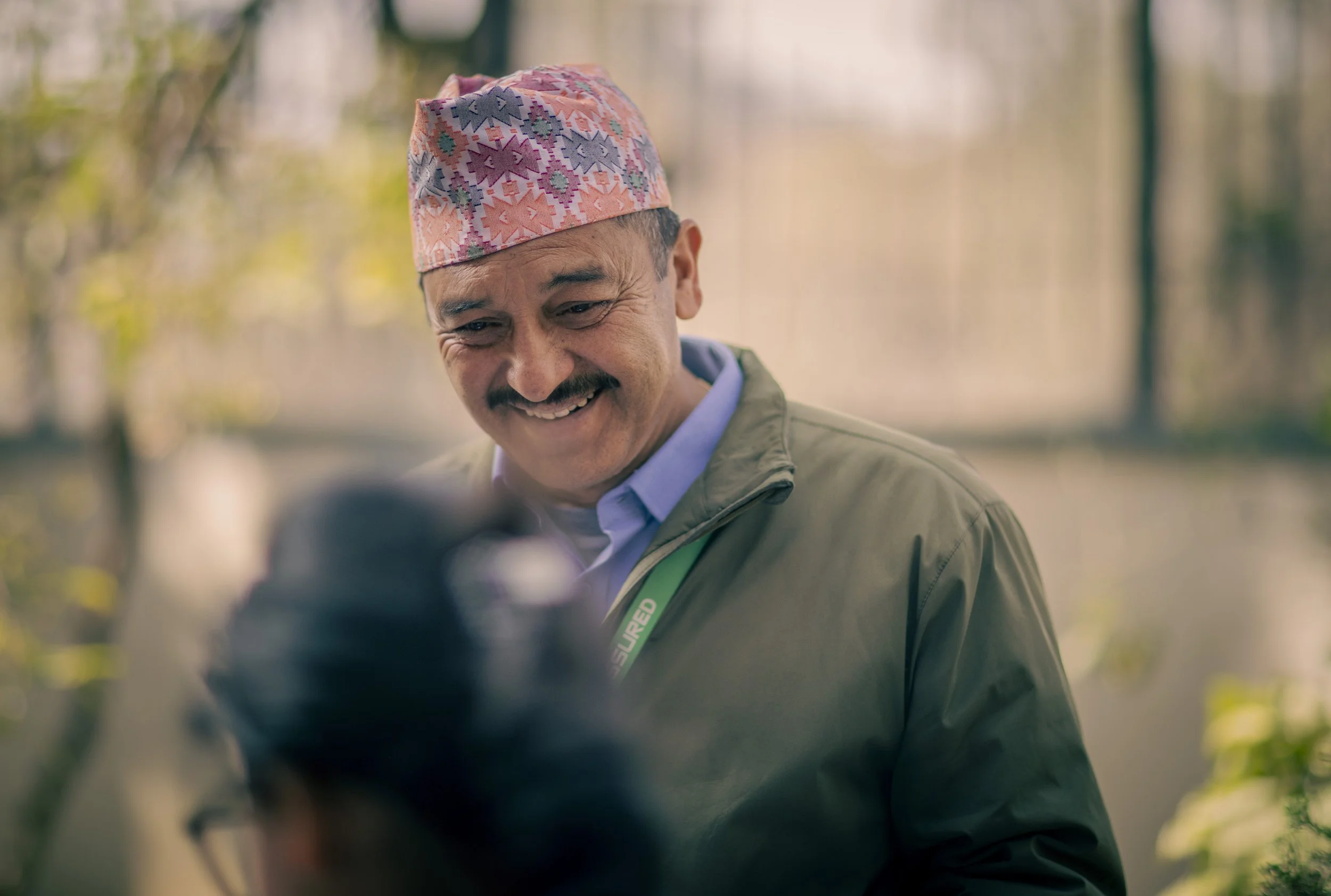 concierge smiling portrait traditional Dhaka topi Tilganga Eye Institute Kathmandu Nepal Simon Shattky
