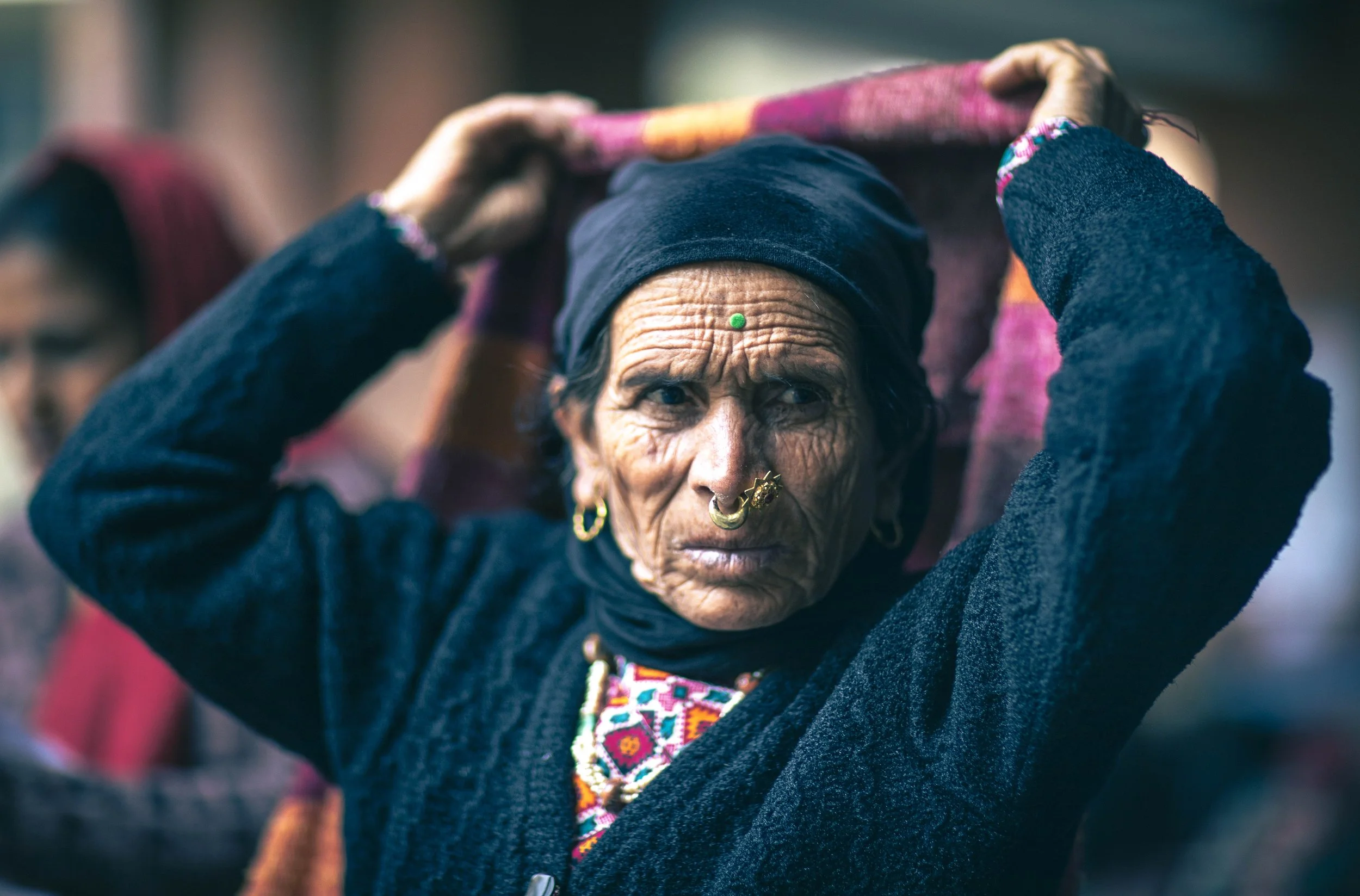 Elderly Nepalese woman traditional dress adjusting headscarf portrait Tilganga Eye Institute Kathmandu Nepal Simon Shattky
