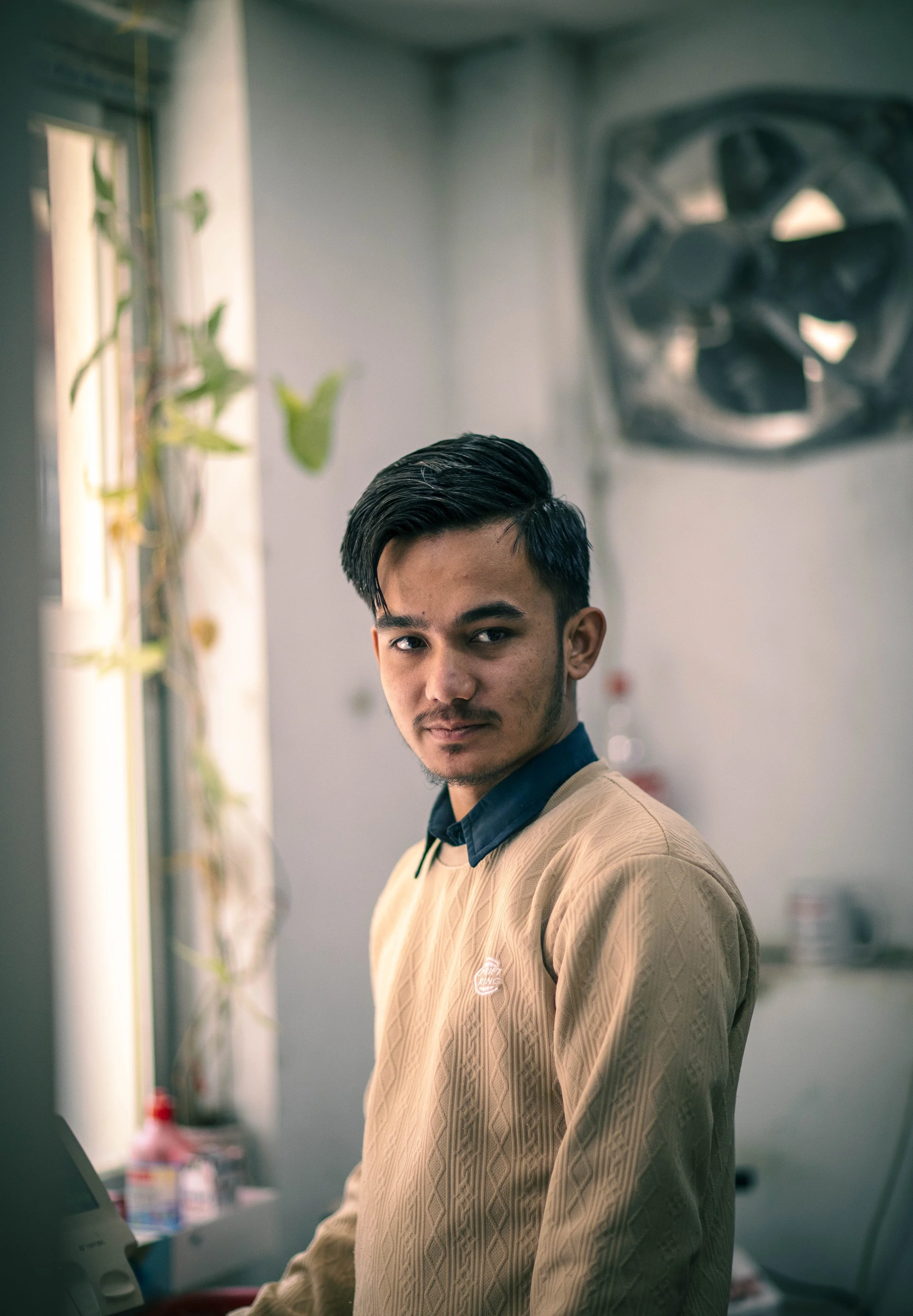 Young man at glasses dispensary natural light Tilganga Eye Institute Kathmandu Nepal Simon Shattky
