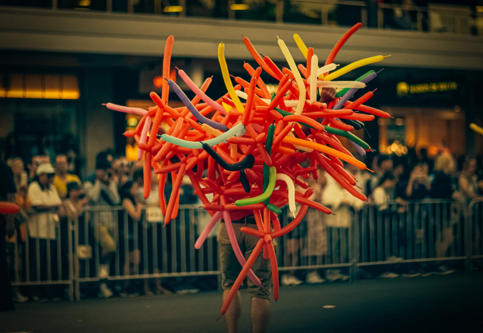 Man hidden by huge bunch of balloons Ponsonby road pride parade. Candid shot Simon Shattky
