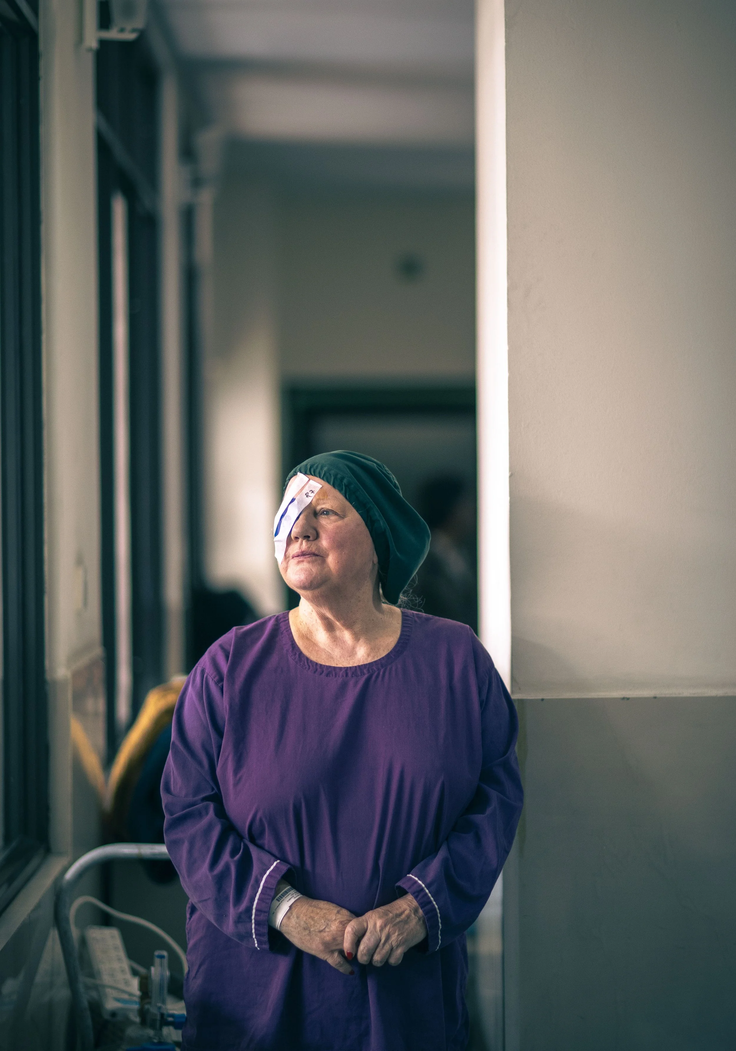 Angela Griffen after cataract surgery bandaged eye corridor Tilganga Eye Institute Kathmandu Nepal Simon Shattky

