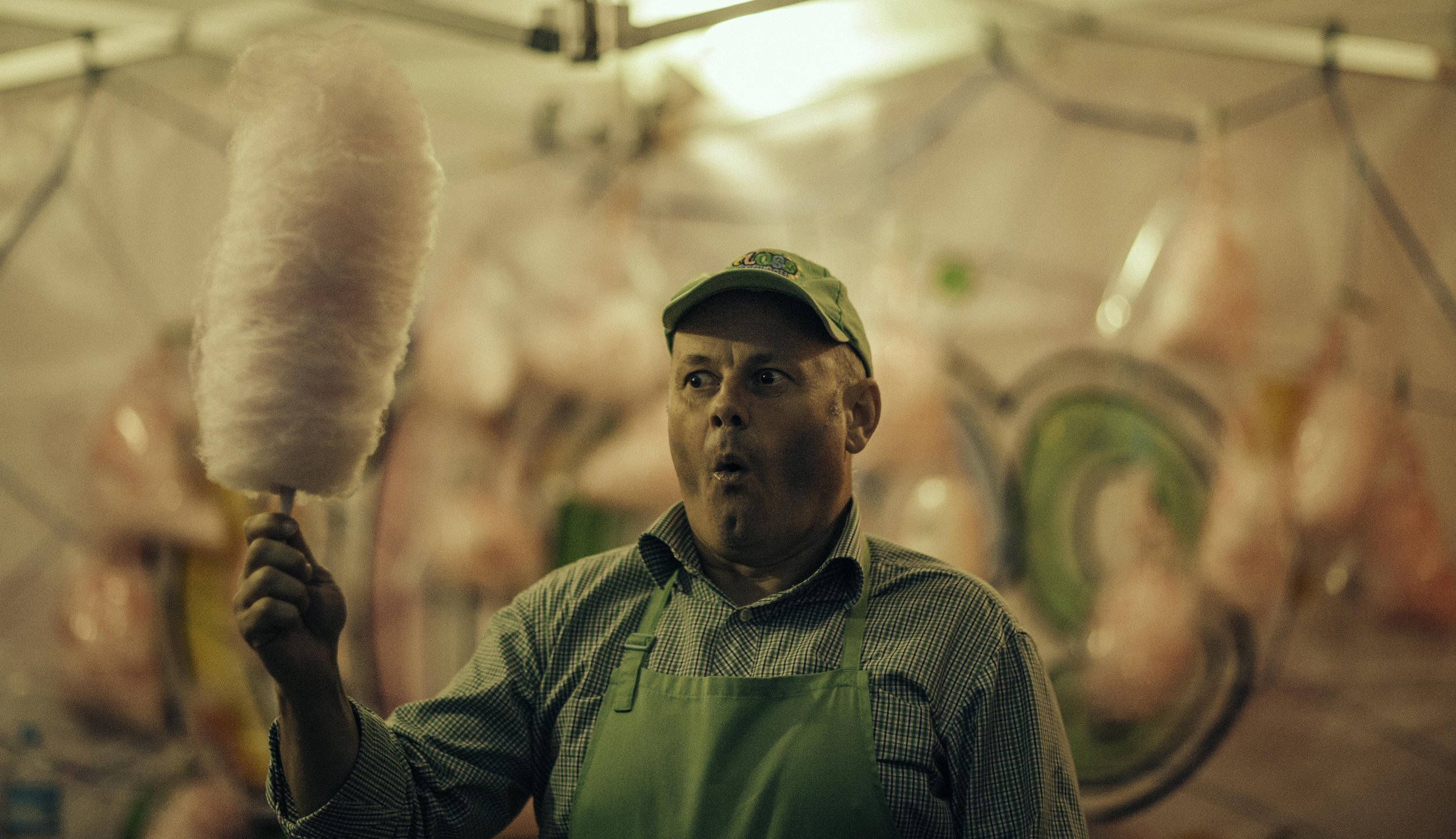 Man Candy floss seller at auckland easter show. Candid street portrait photography by simon shattky
