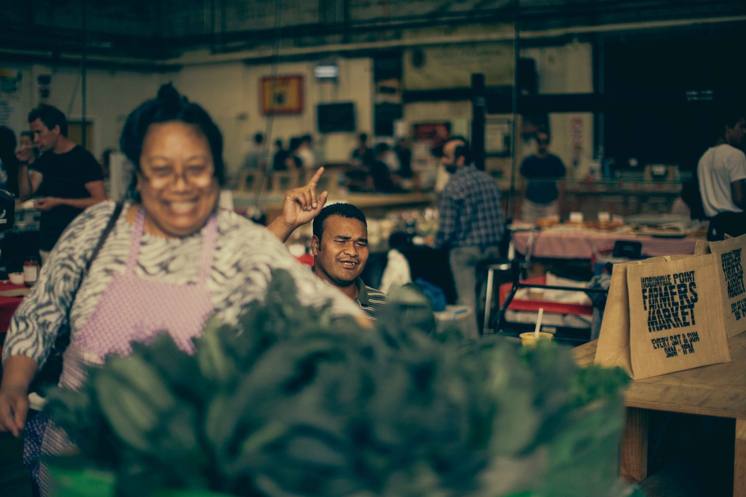 Candid portrait man laughing street food market auckland photographer Simon Shattky
