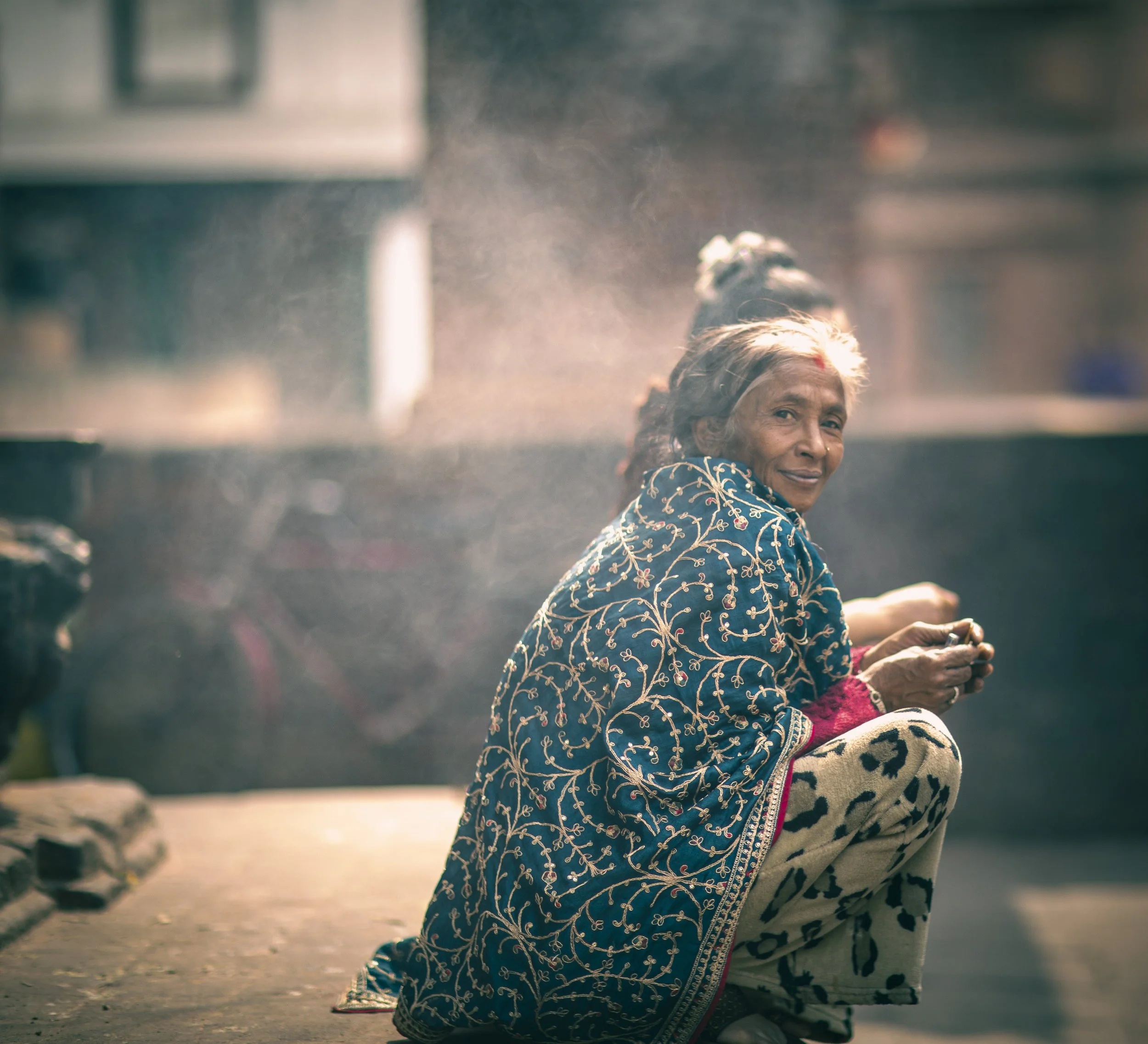 Candid portrait elderly woman colourful scarf at Kathmandu Durbar square street photography Simon Shattky
