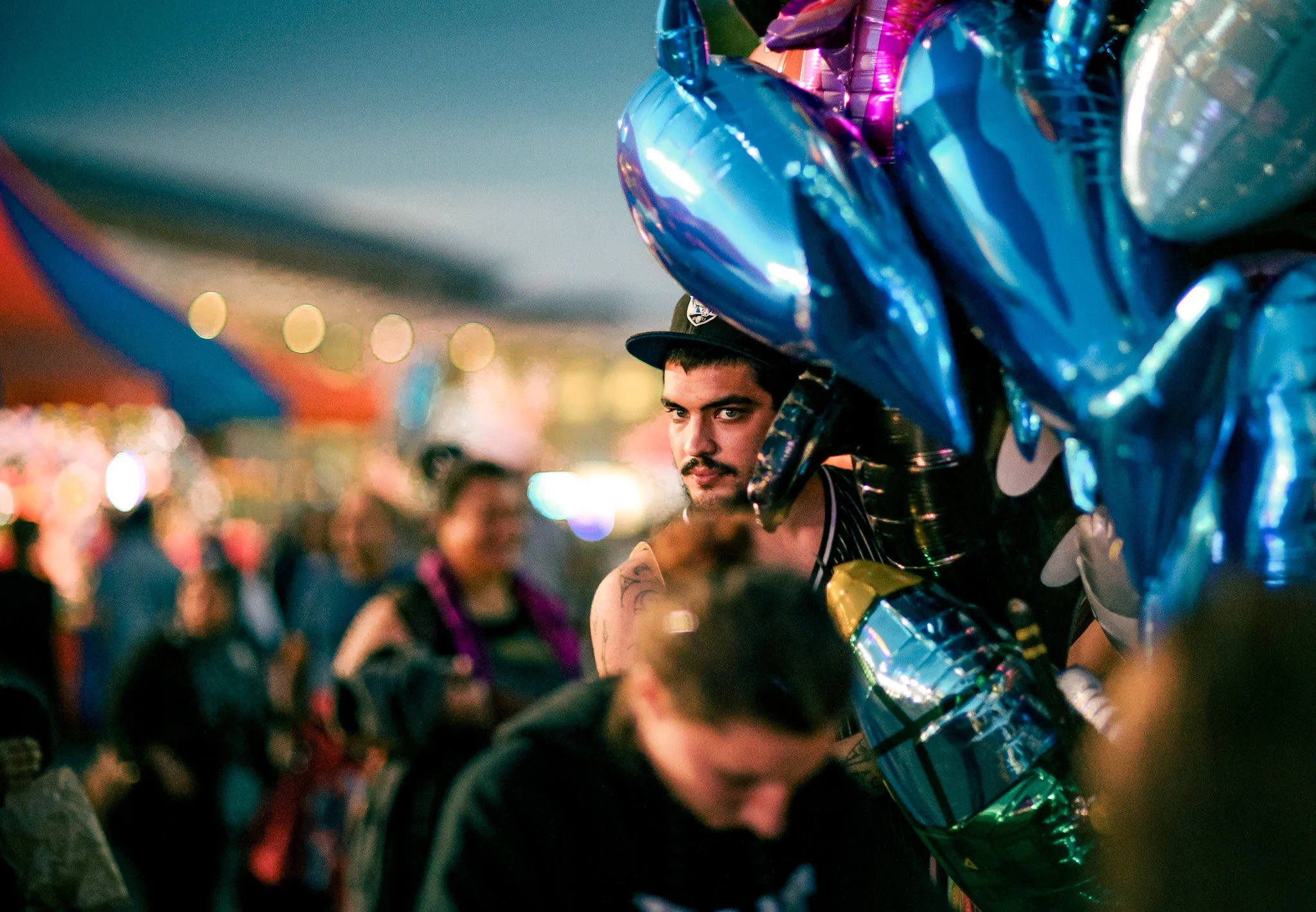 Candid portrait man bunch blue balloons auckland easter show  Simon Shattky

