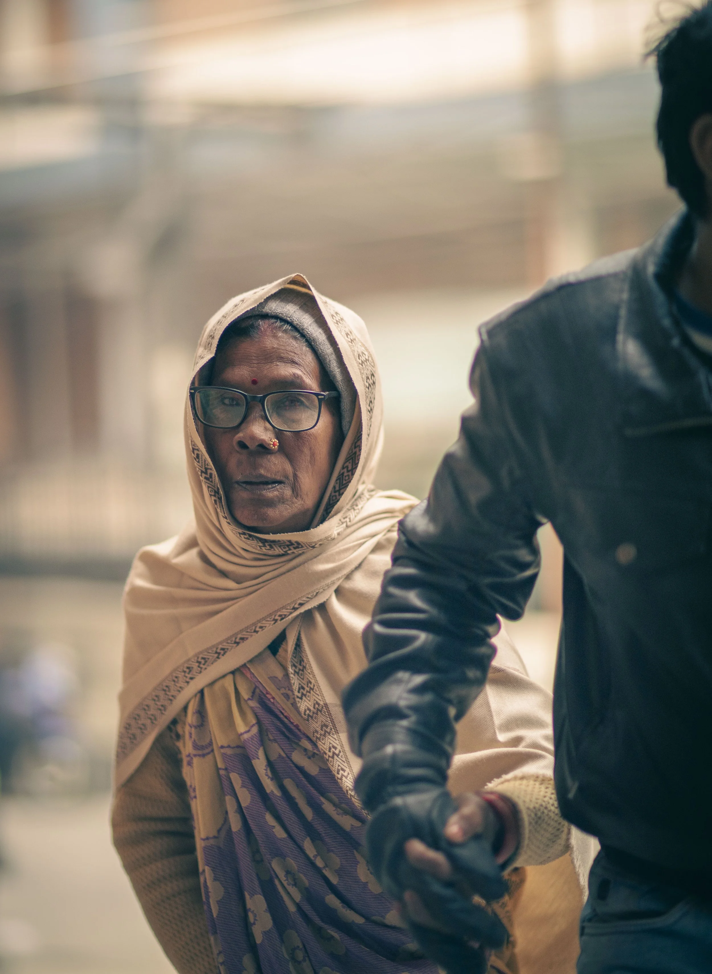 Elderly woman patient being guided by son Tilganga Eye Institute Kathmandu Nepal Simon Shattky

