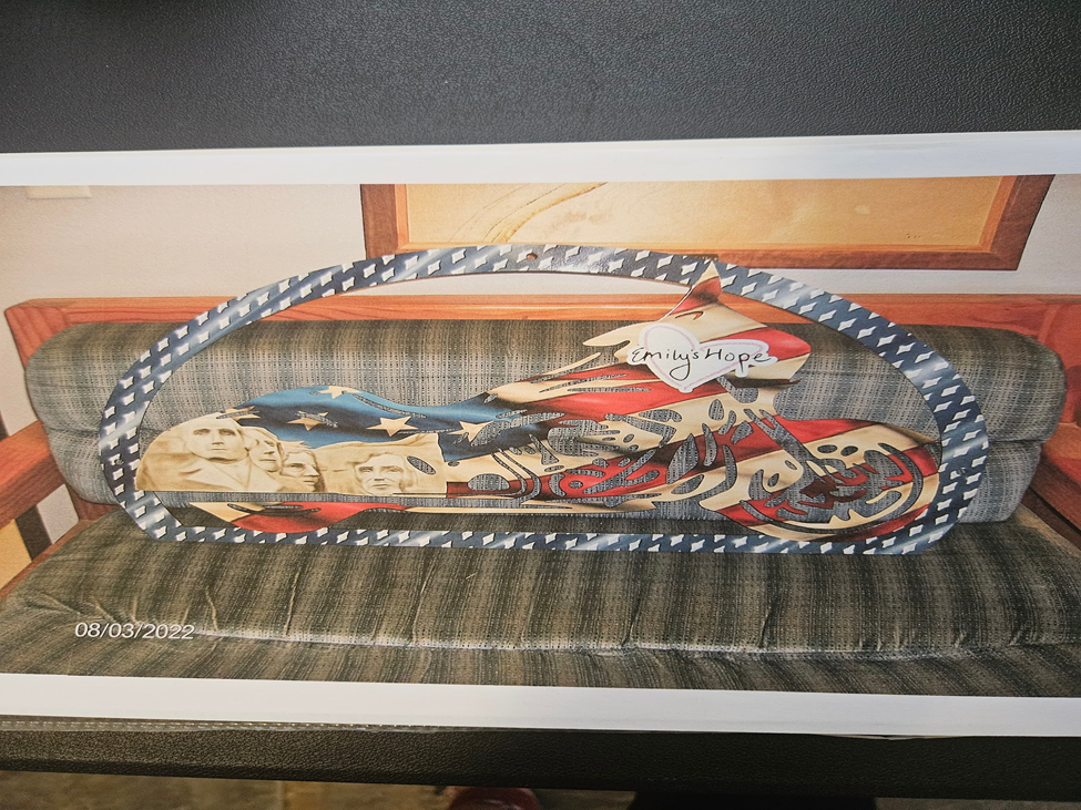 Custom airbrush motorcycle artwork with American flag design and Mount Rushmore detail on metal panel