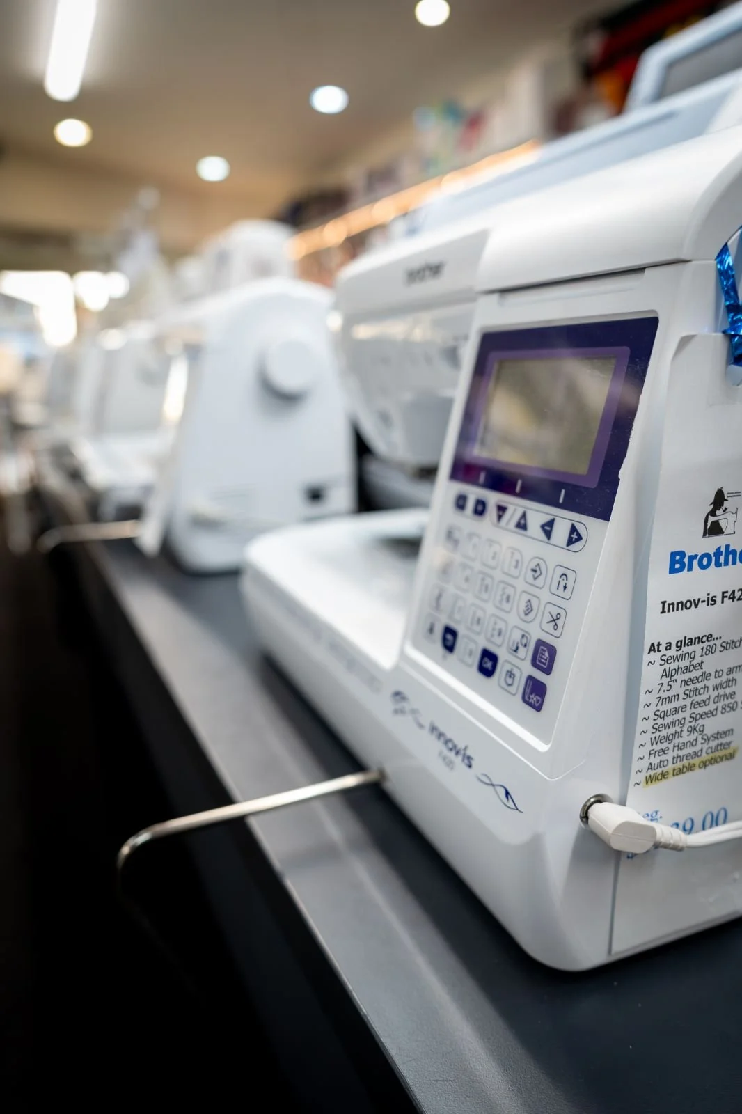 A close-up view of a Brother Innov-is F420 sewing machine on display.