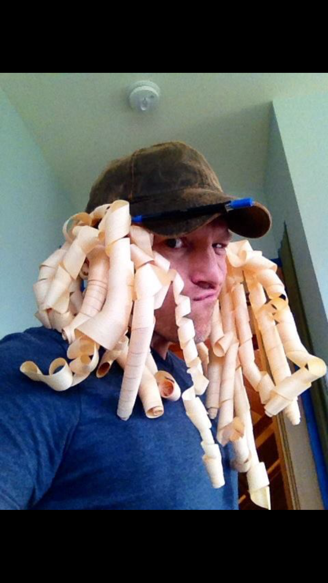 Ark Built Carpentry founder Matt Behnke goofing around with wood trimmings as a wig