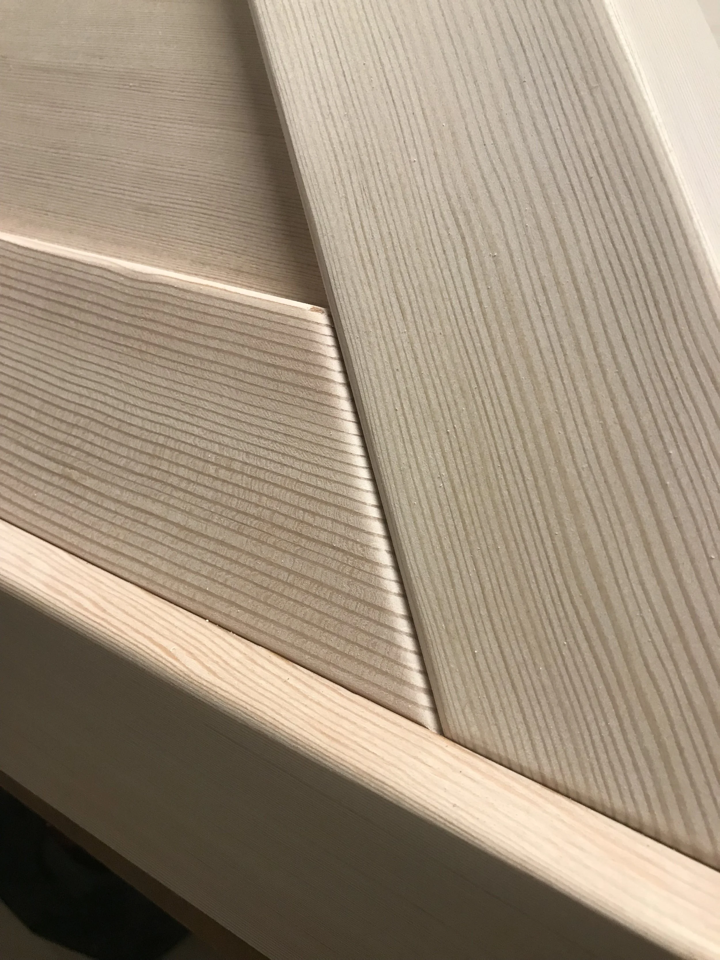Ark Built Carpentry Close-up of wooden kitchen vent cover with a light wood finish.