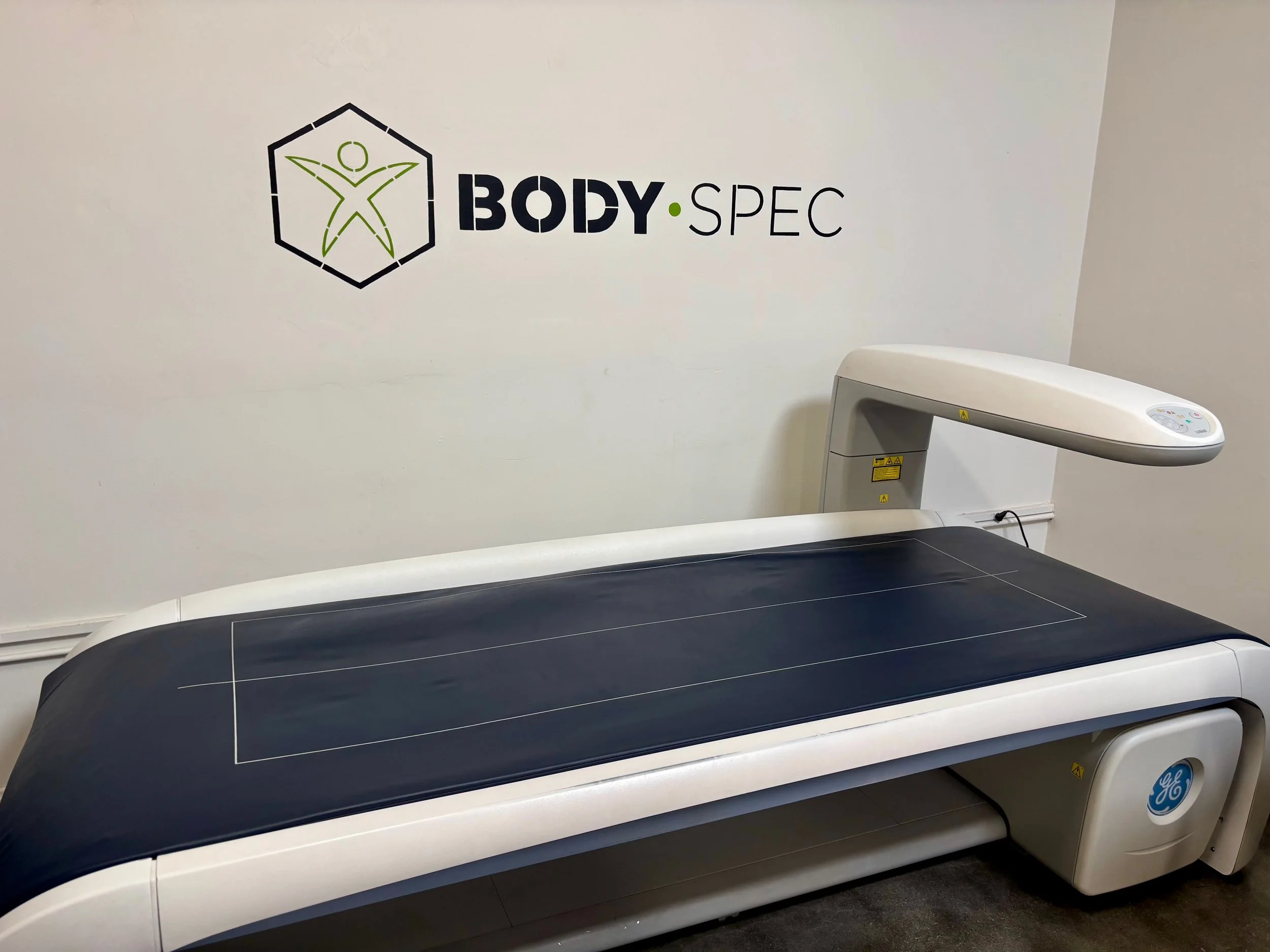 A crisp, clinical photo of the DEXA machine the AllGreenLightsCEO laid on for the April 1, 2026 scan.
