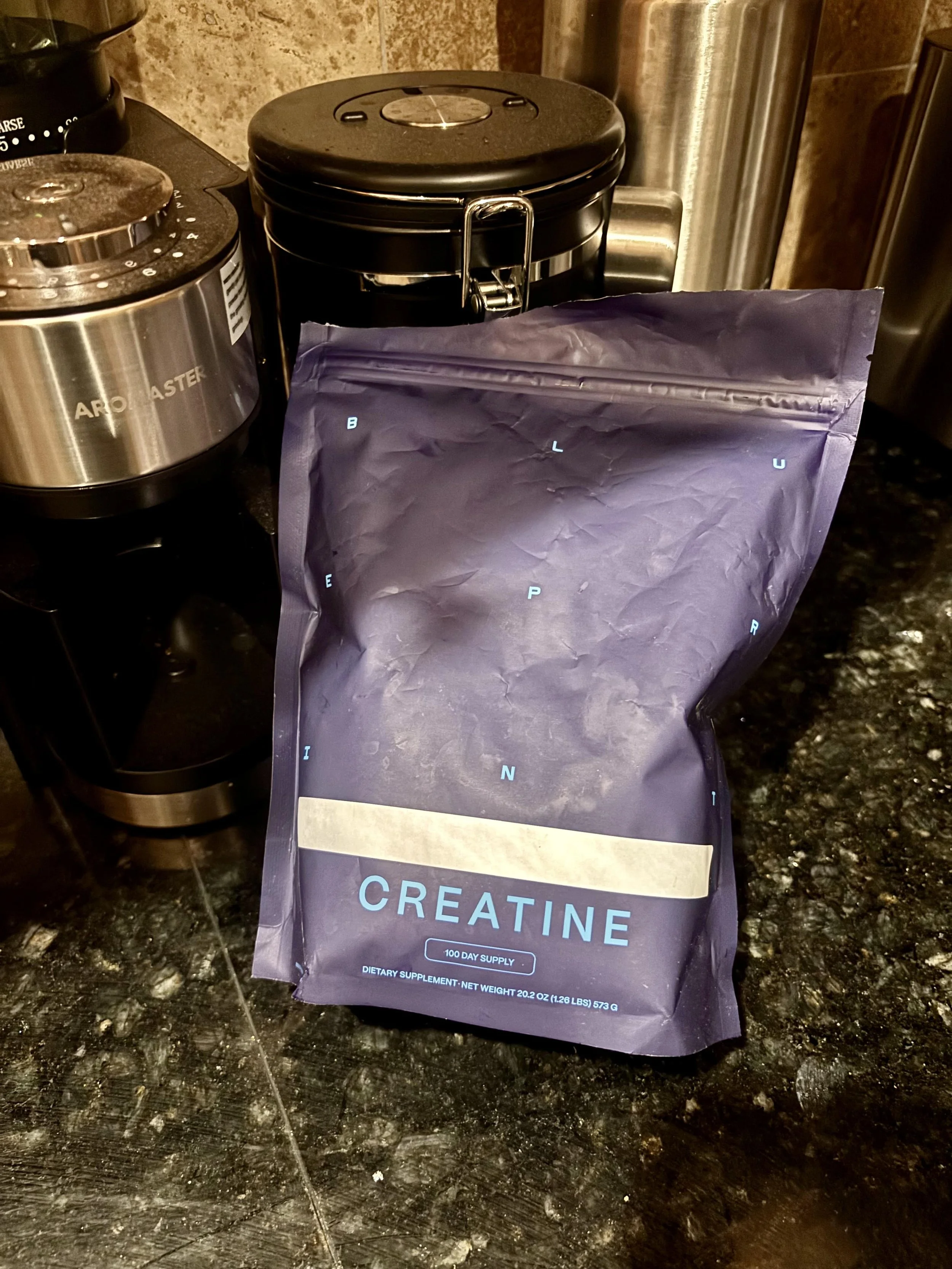 A clean, high-resolution photograph of a blue bag of Blueprint Creatine Monohydrate. This is a daily supplement used in my three-month experiment to track skeletal muscle mass gains and hydration.
