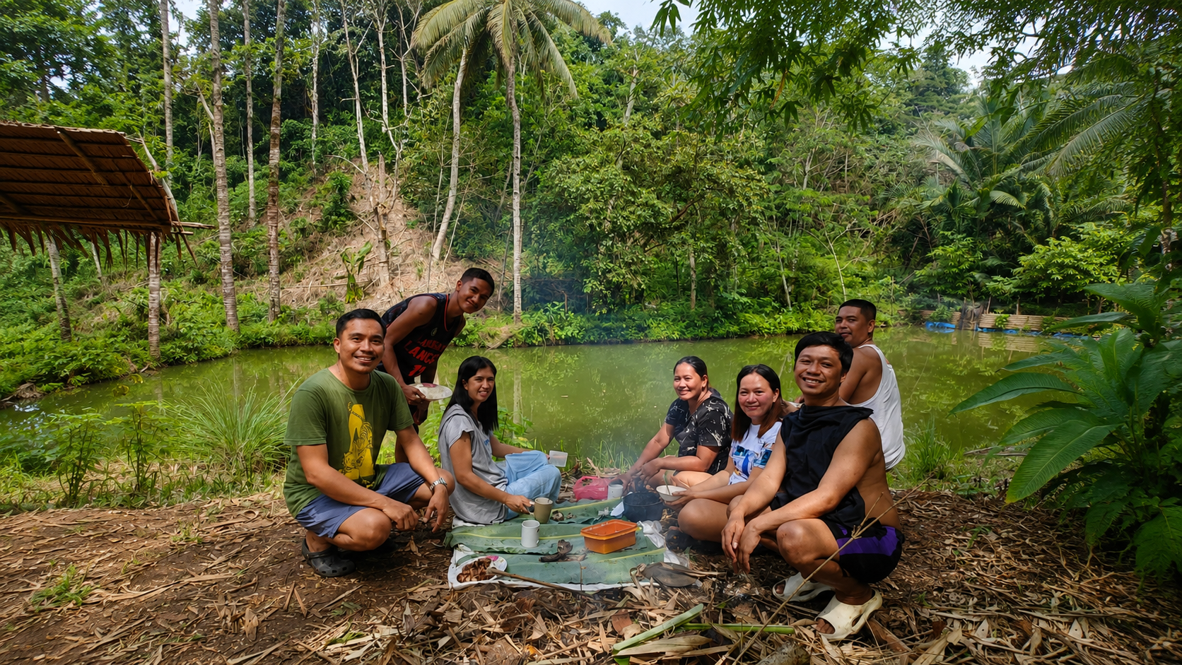 Family sharing a picnic beside a forest pond in the tropical Philippines, inspiring the ending of The Hidden Treasure, where Juliet discovers that the greatest treasures are family, friendship, and time together.