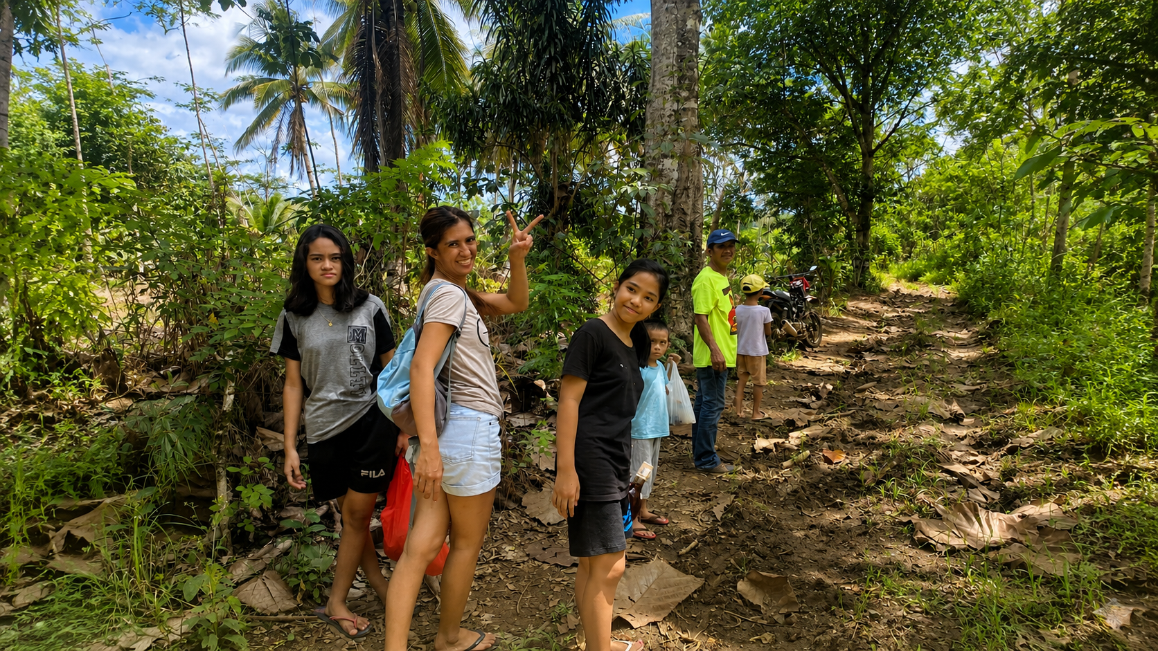 Family exploring a tropical forest trail in the Philippines, one of the real landscapes that inspired the stories of Piggery Adventure Tales.