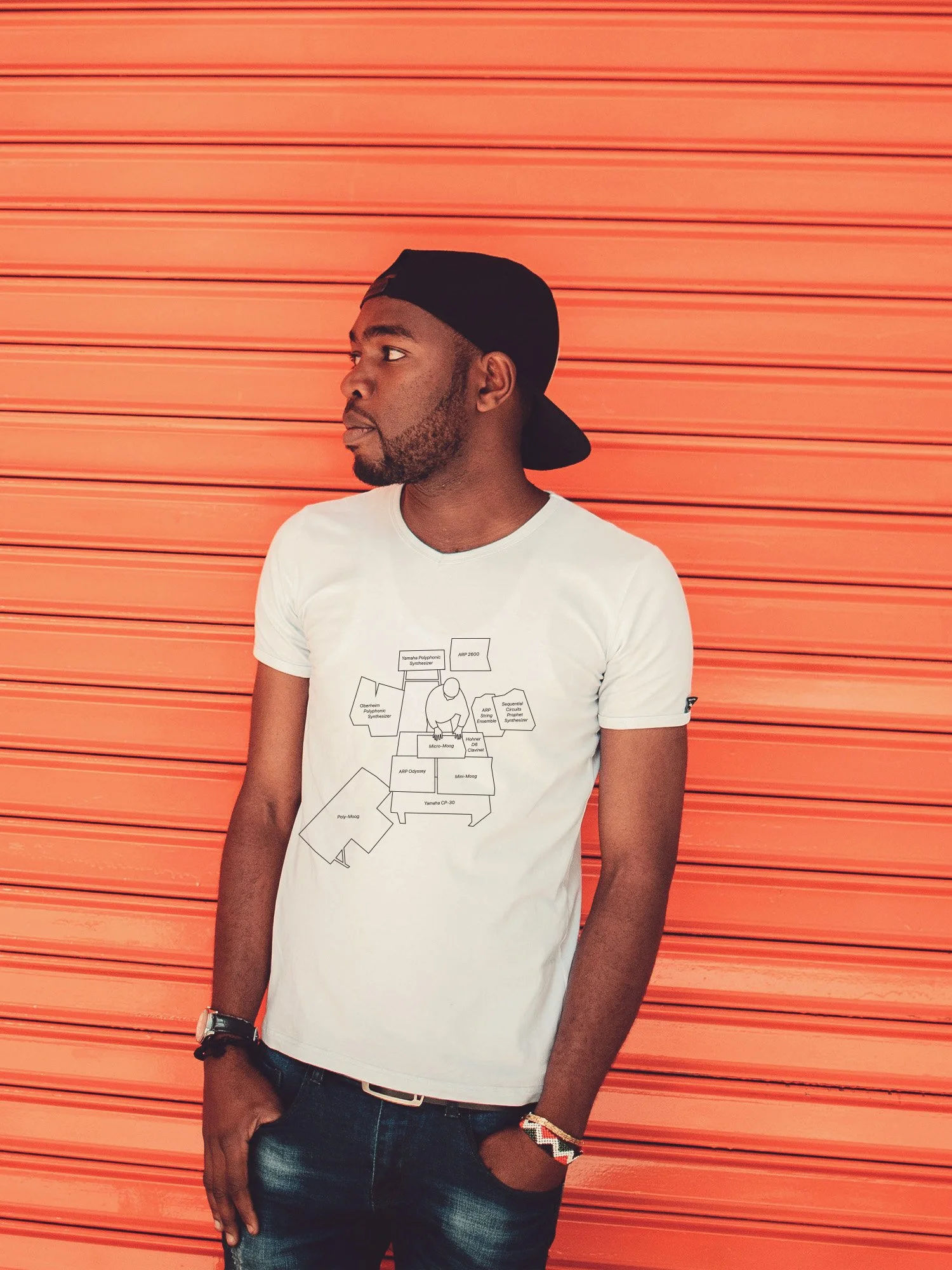 A man wearing a t-shirt featuring a diagram of Herbie Hancock playing a massive setup of synthesizers and keyboards – all 11 labeled.