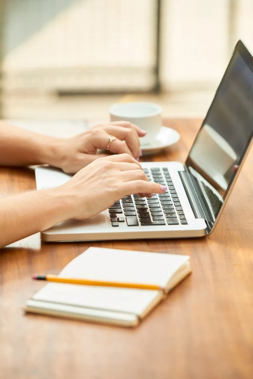 Woman typing at computer