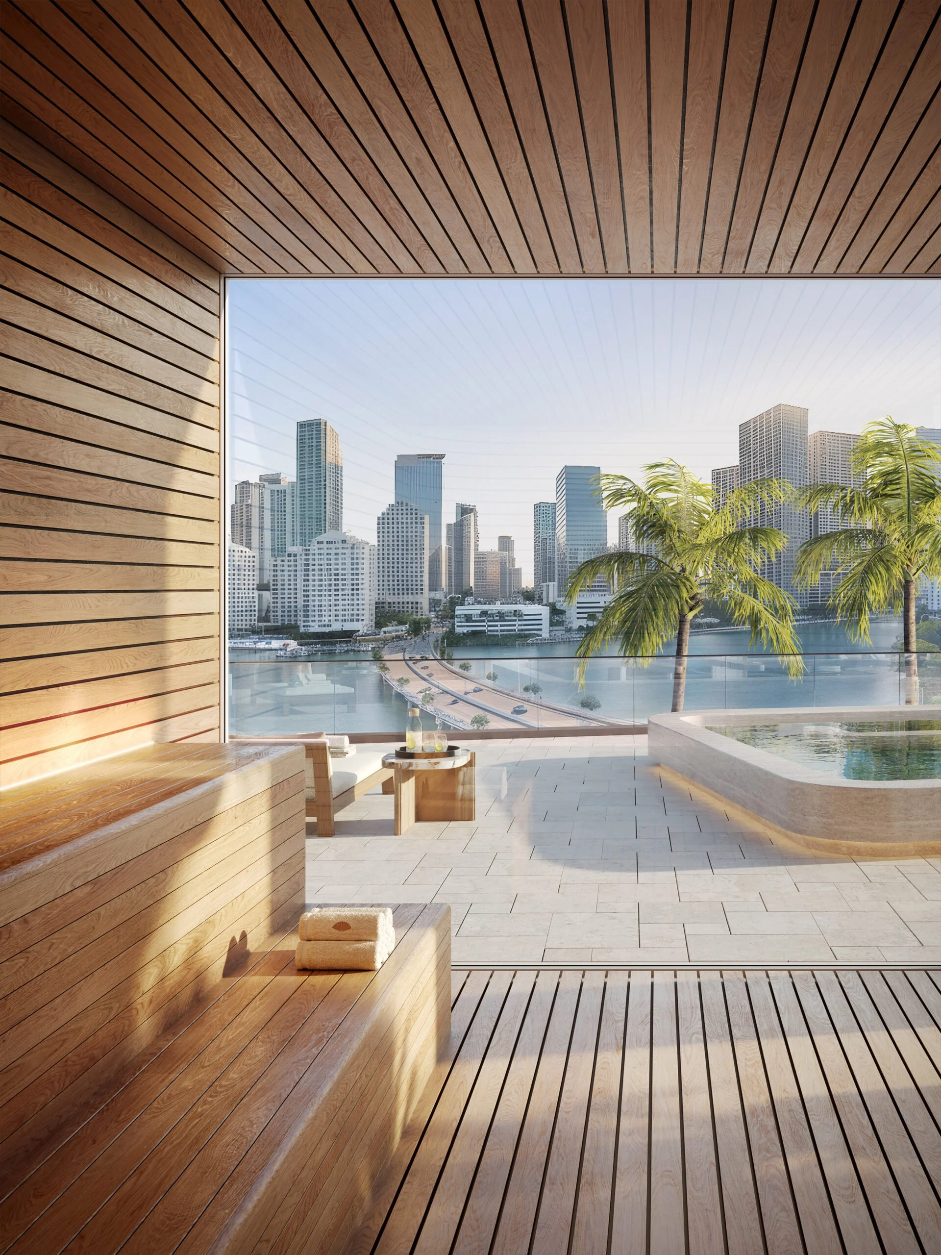 Modern outdoor spa area with wooden decking and walls, overlooking a city skyline with tall buildings, palm trees, and a river.