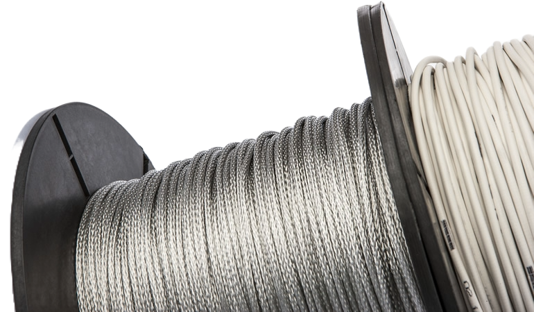 Close view of Calorflex SPCx braided silicone heater cable on reels