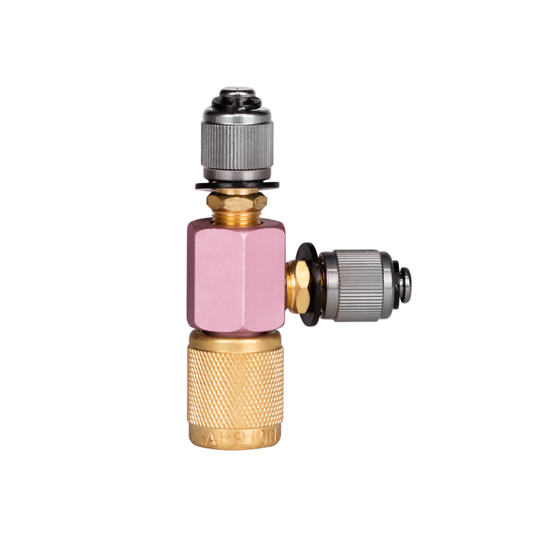 Close-up of a brass and metal valve fitting with pink plastic connectors and black adjustment screws.