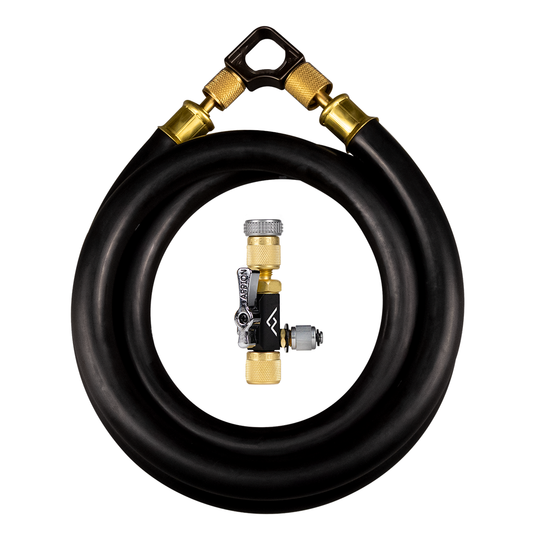 Close-up of a coiled black hose with brass fittings, viewed through a machined metal assembly with a lever and threaded components.