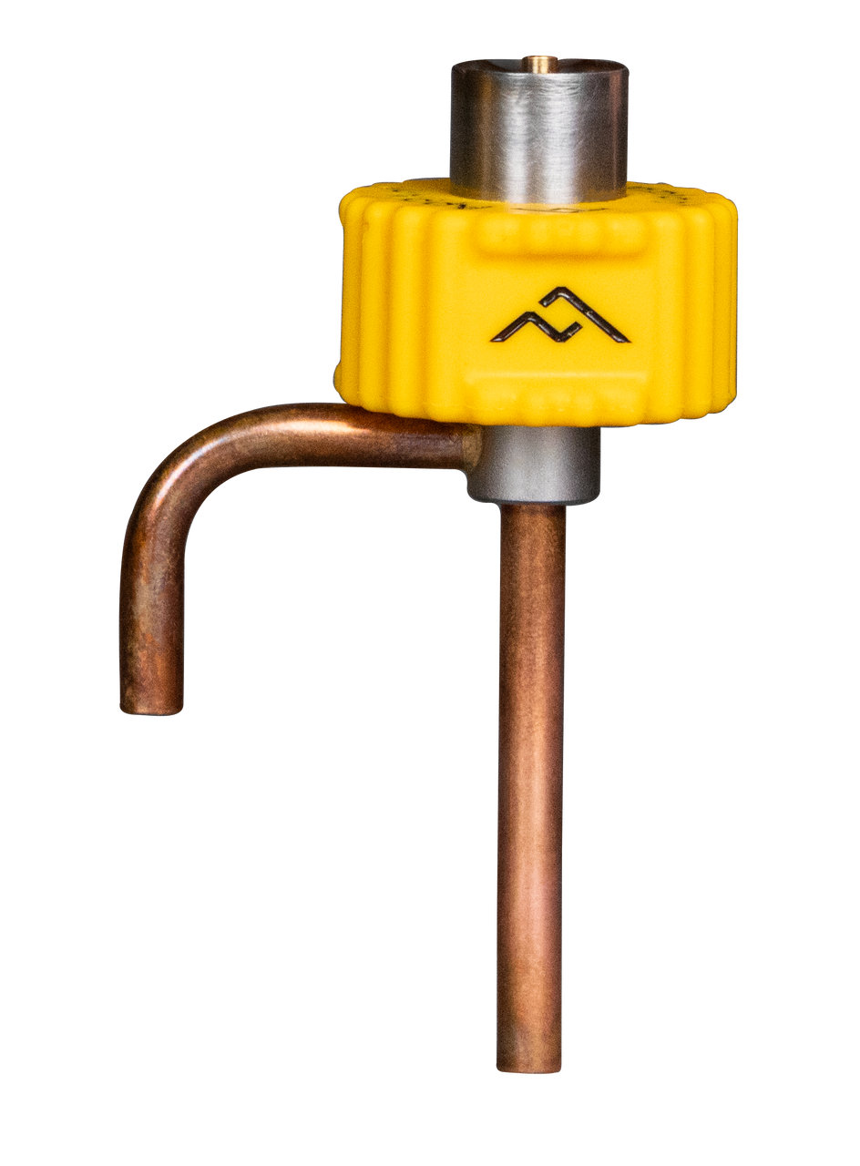 A close-up of a brass and copper pipe fitting with a yellow valve handle and a black arrow symbol.