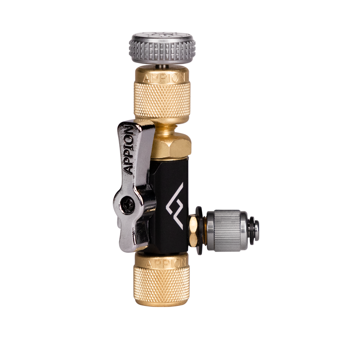 Close-up of a specialized bicycle or vehicle part with brass, silver, black, and gray components, including a small lever.