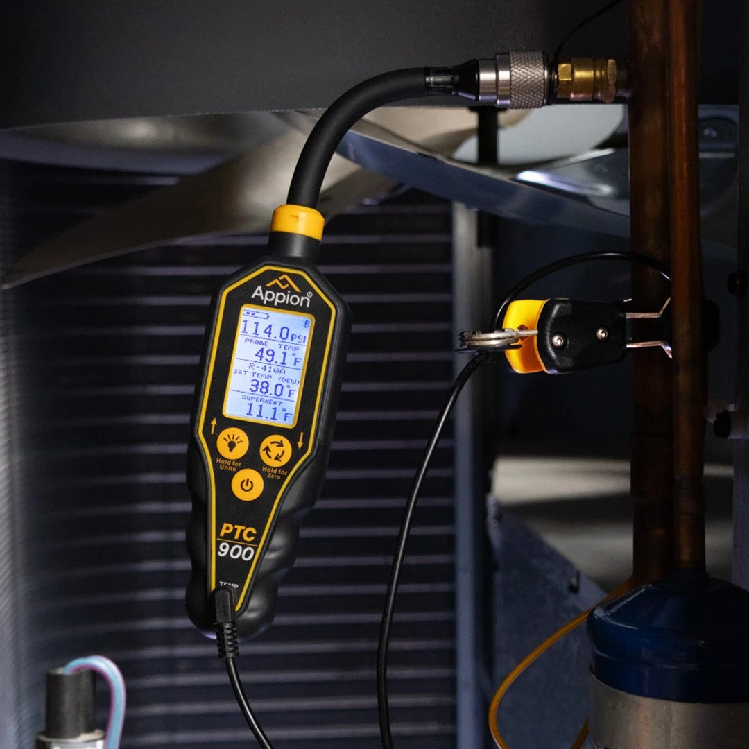 Digital pressure and temperature gauge connected to a pipe; reading 114.0 PSI, 49.1°F, and 38.0°F.