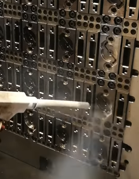 Close-up of plastics moulds being cleaned in-situ using dry ice blast cleaning.