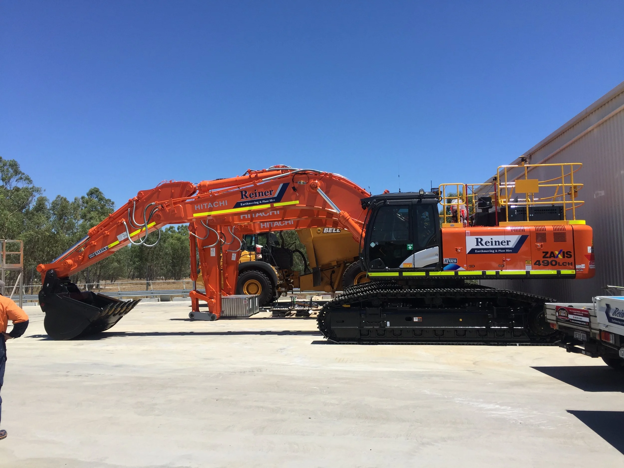 Large scale excavator fitted with Reiner Earthmoving branding, high-visibility DG3 striping and Asset Numbers.