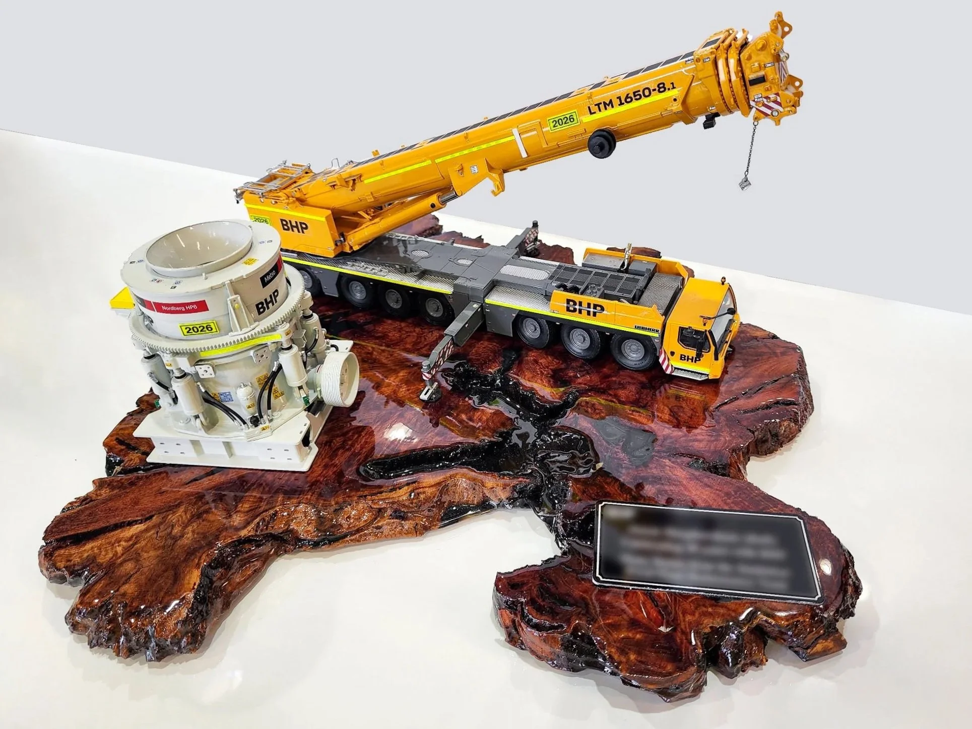 Model of a satellite and a crane on a wooden base, with a plaque. Custom mining gifts