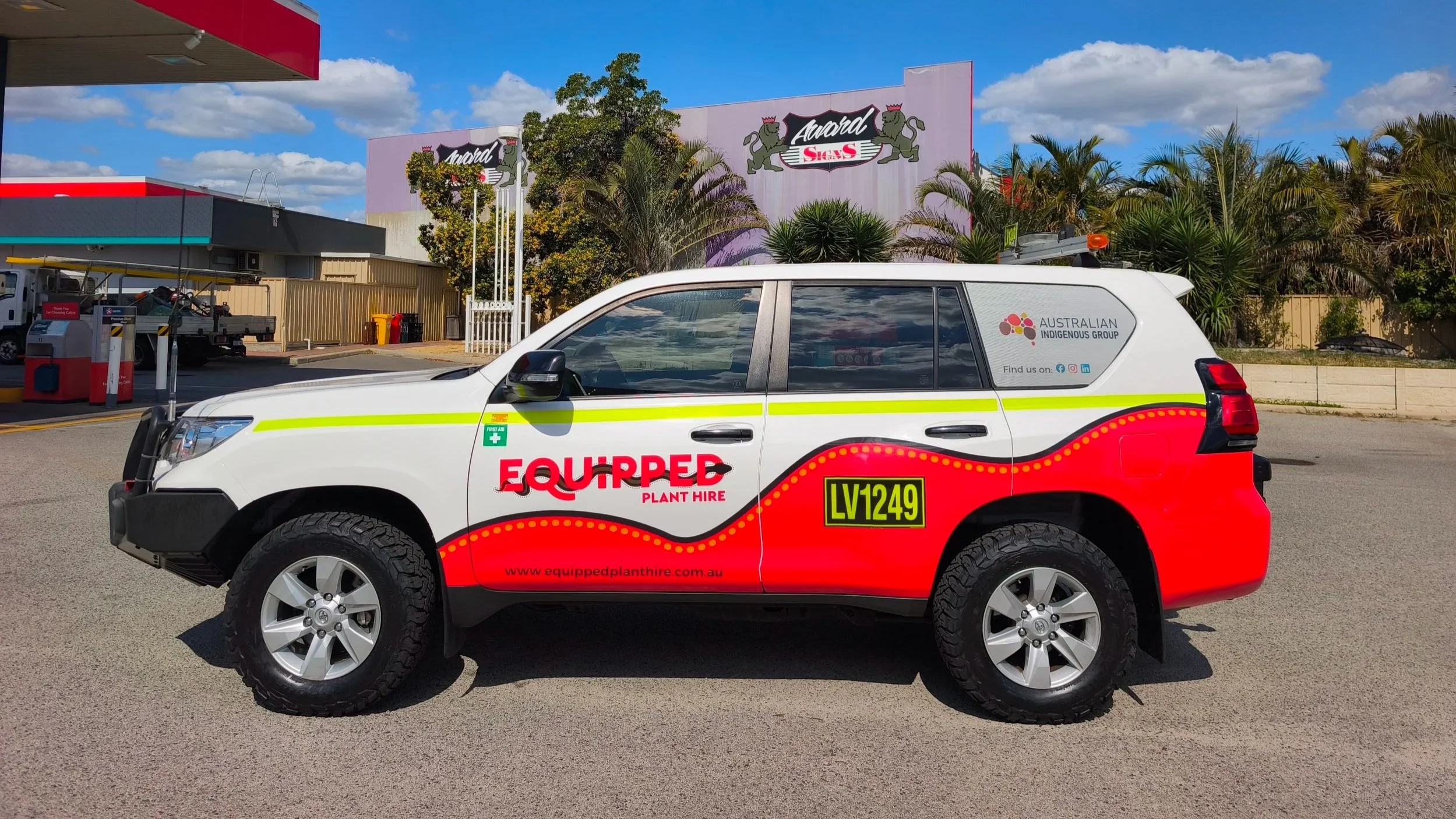 A Toyota Prado fitted with vibrant branding and partial wrapping for Equipped Plant Hire with high-visibility DG3 striping and Asset Numbers.