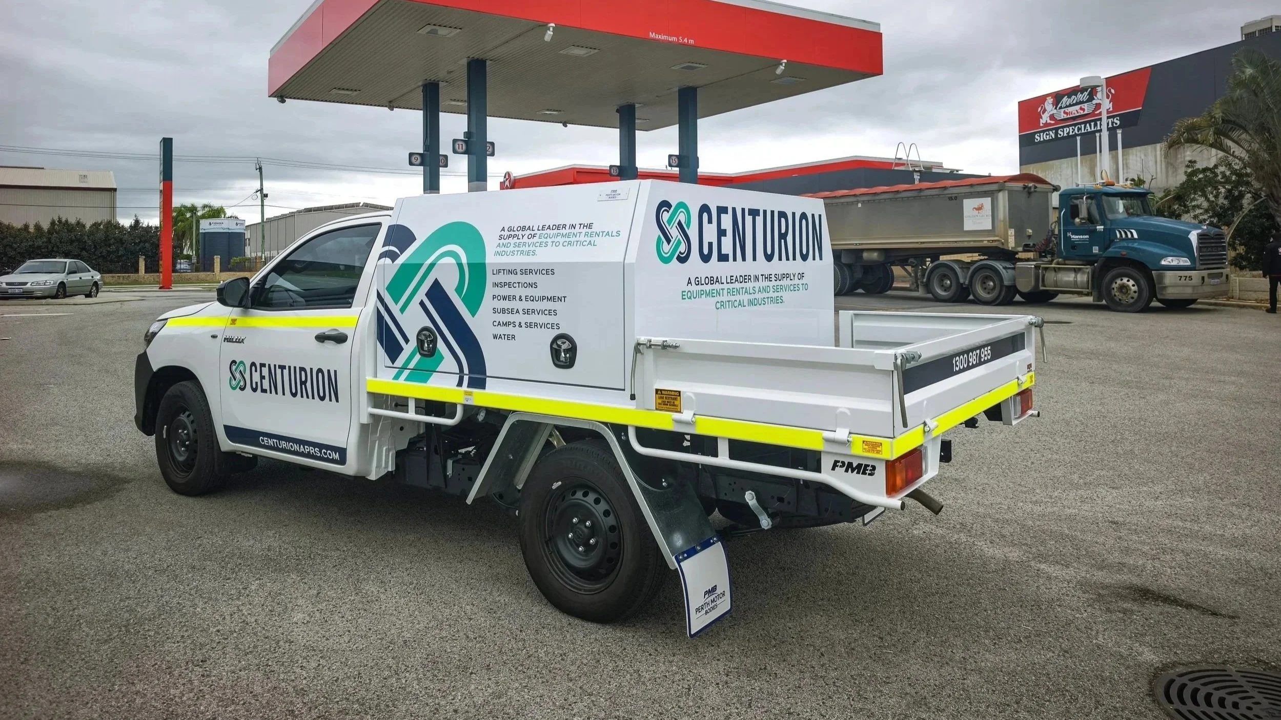 A white Toyota Hilux service vehicle fitted with Centurion branding and high-visibility DG3 striping and Asset Numbers.