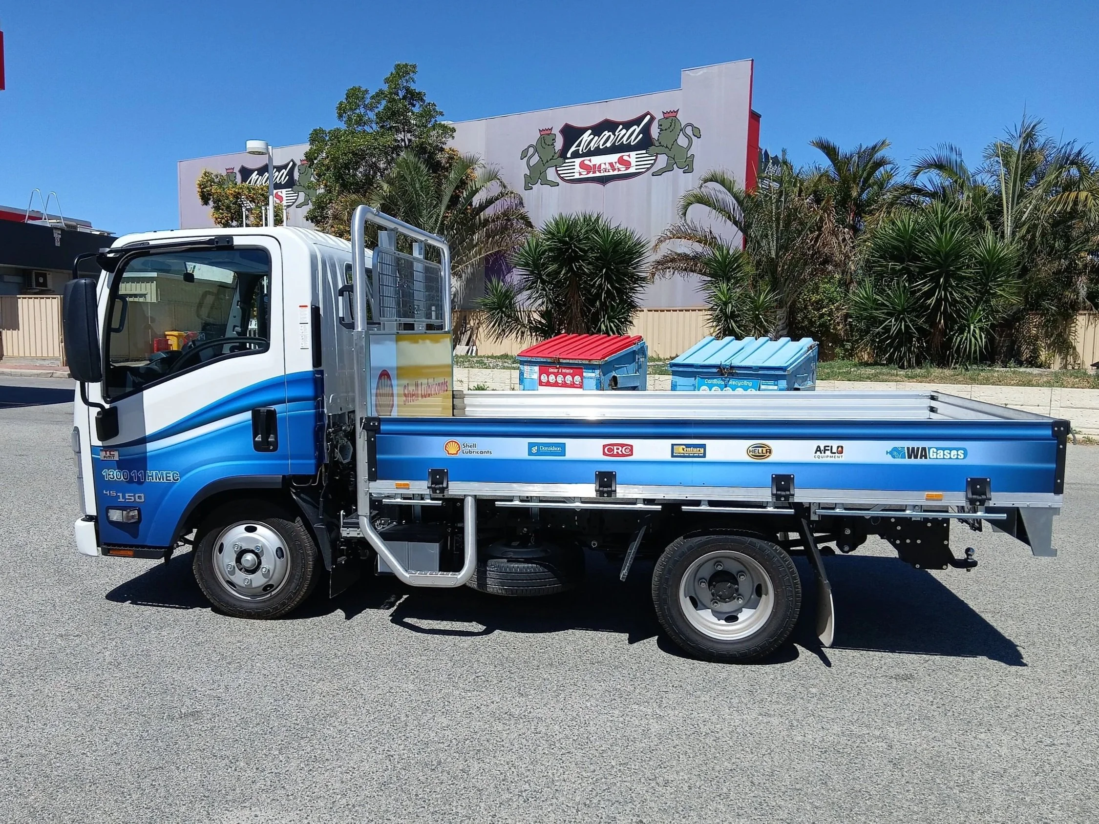 A small truck wrapped with HMEC branding wrapped on the cab and tray. Vehicle branding