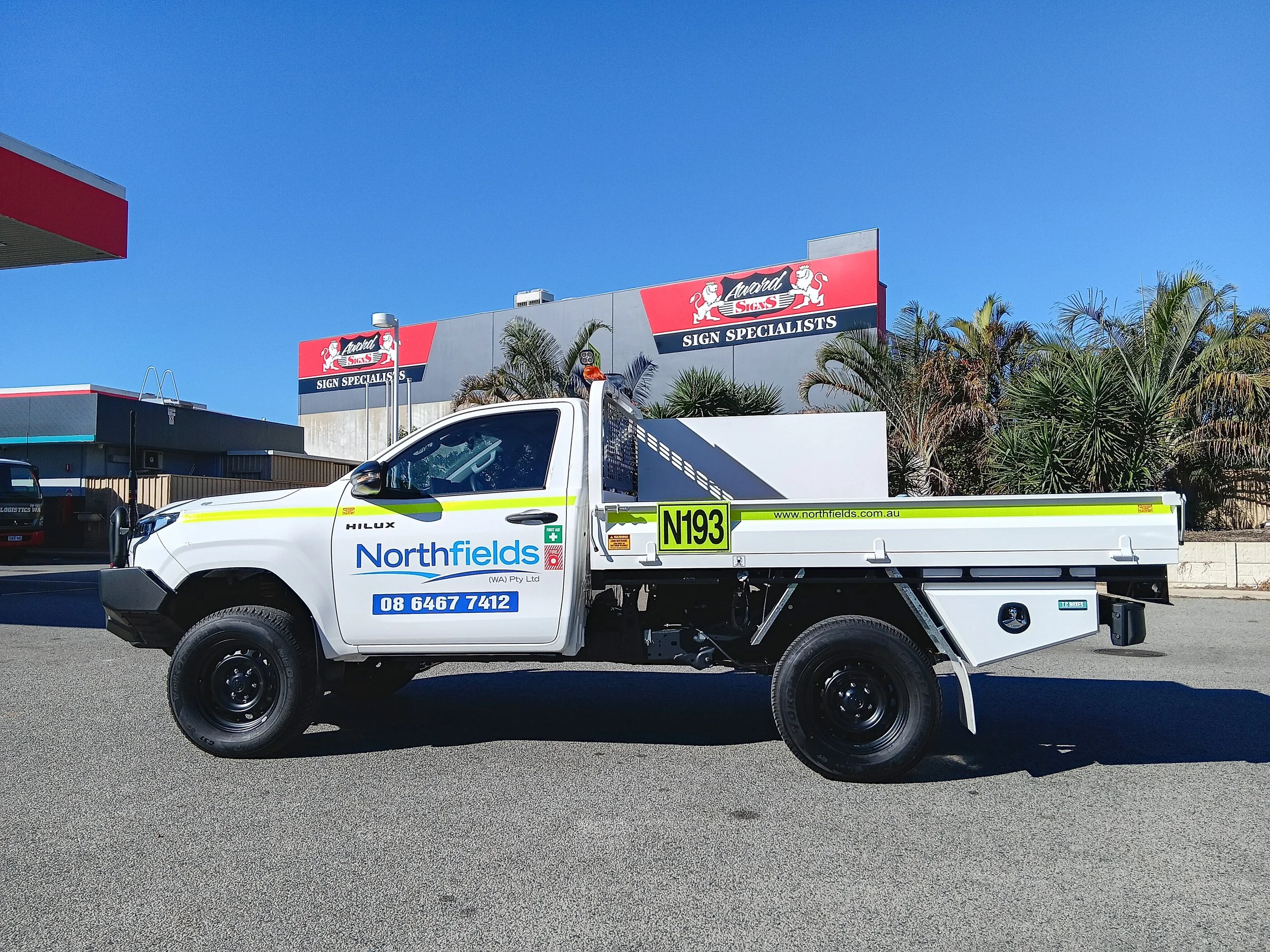 A white Northfields service vehicle Toyota Hilux with Northfields branding and high-visibility DG3 striping and Asset Numbers.