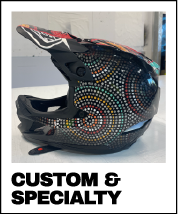 A colorful, patterned wrapped motorcycle or mountain bike helmet with dot painting designs - custom and unique wraps