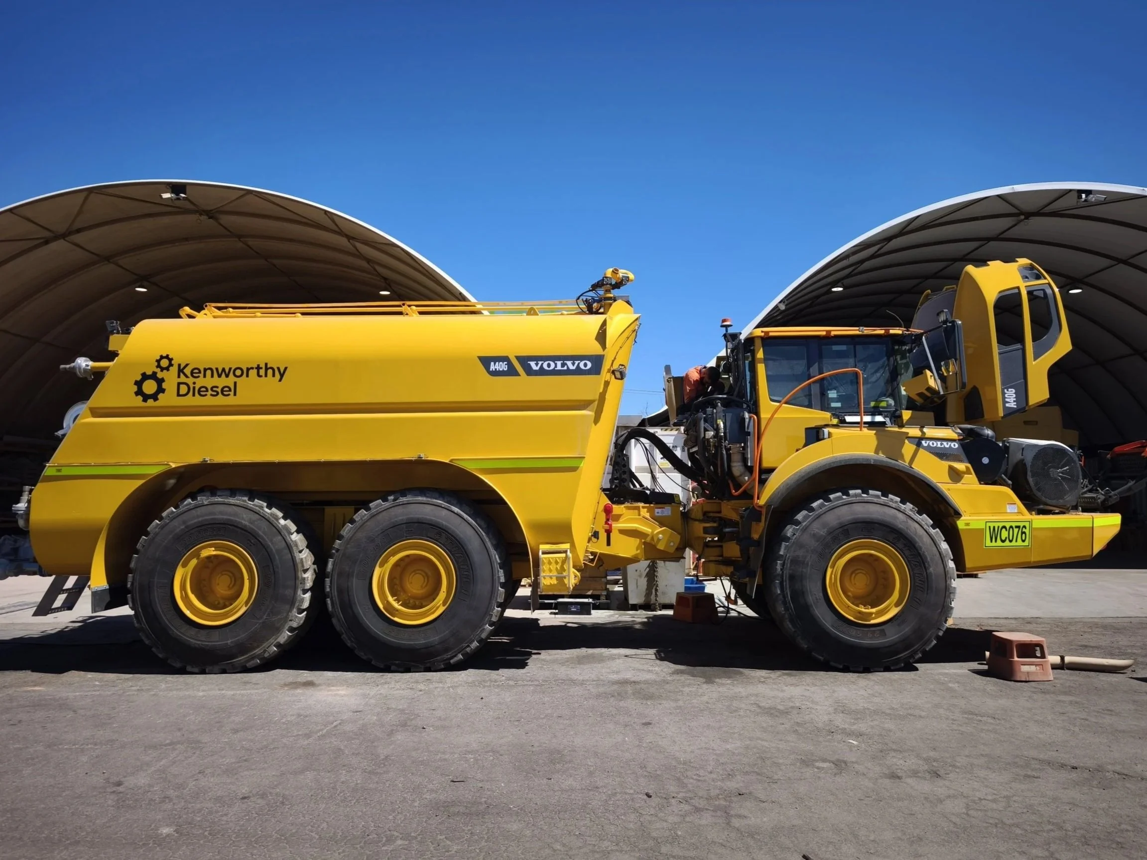 A bright yellow Volvo Water Cart with Kenworthy Diesel decals in Perth, WA. Truck Signage Perth, WA. Truck Decals Perth, WA. Machinery Branding Perth, WA. Mining Decals Perth, WA. Forrestdale Vehicle Signage. Forrestdale Machine Branding.