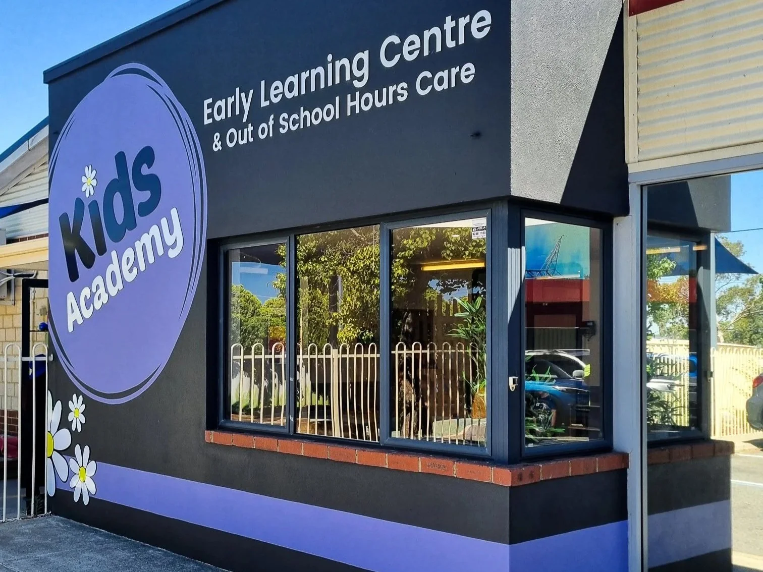 Building with hand painted signwriting and vinyl decals. Childcare business signage
