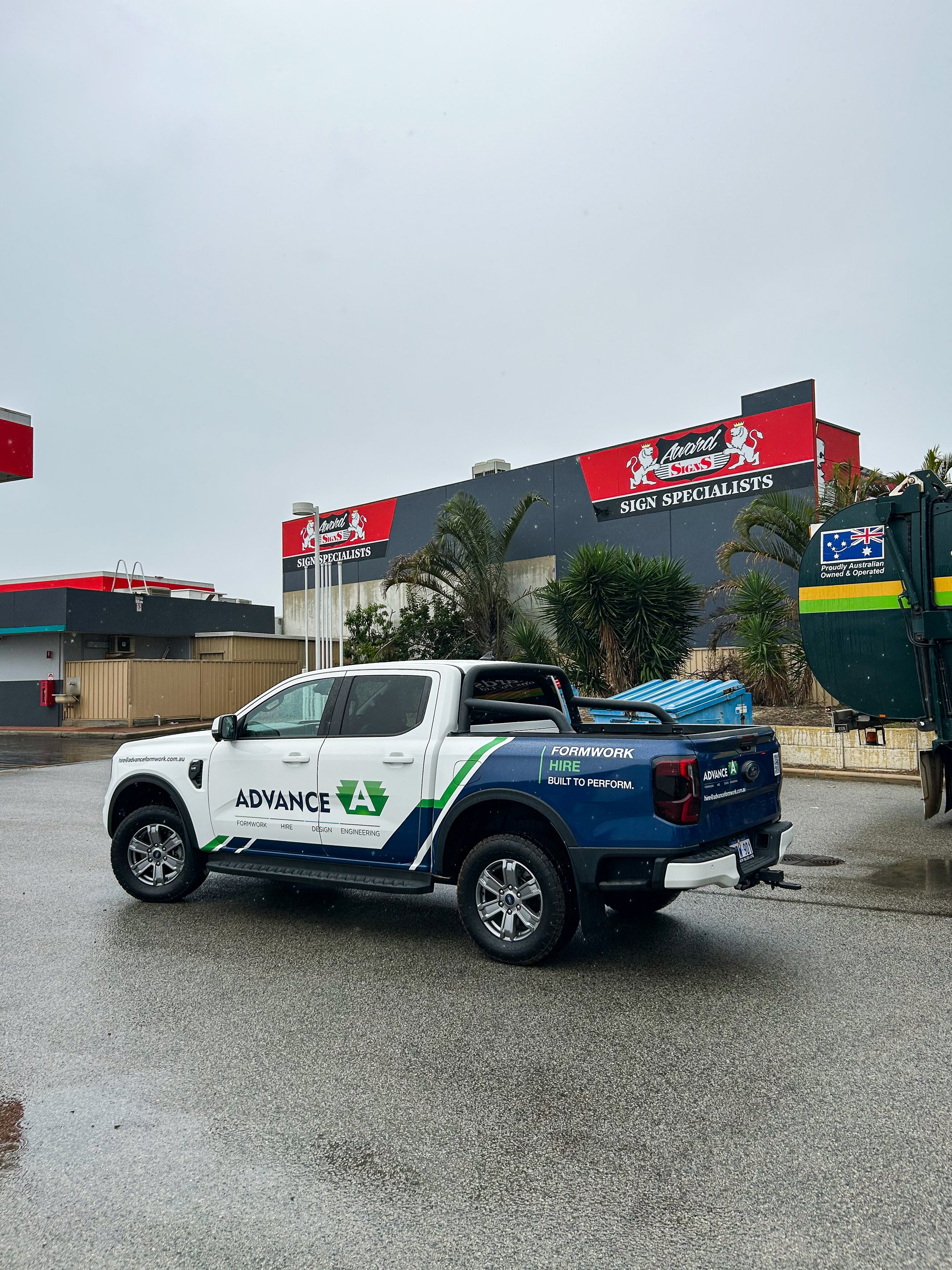A white ford ranger with the logo 'Advance' formwork and a partial wrap advertising the business. Stand-out branding for commercial businesses