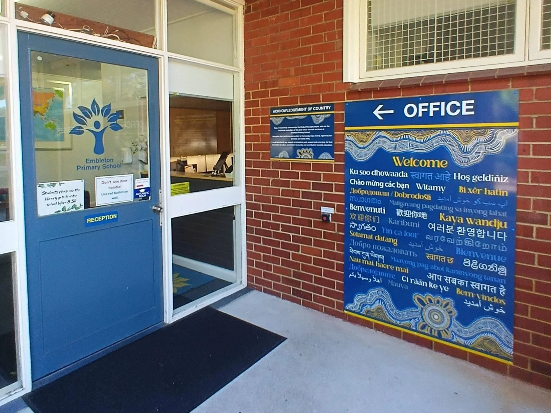 Entrance to Embleton Primary School with door window decals and wall welcome signage. Embleton Welcome Signage. Embleton School Signage. Entrance Signage Embleton. Window Decals Embleton. Window Stickers Embleton.