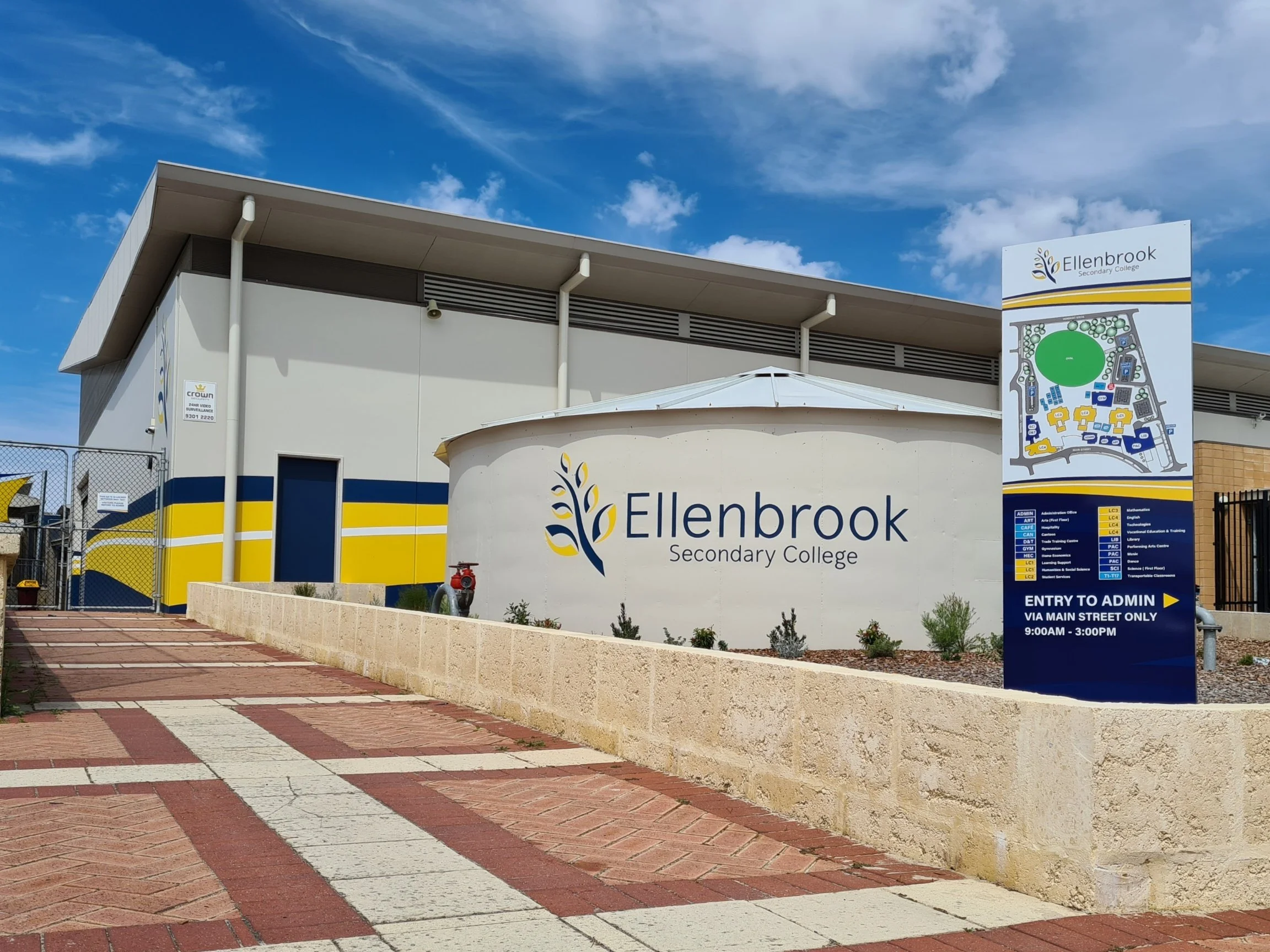 Entrance signage for Ellenbrook Secondary College with a campus map pylong sign, water tank signage and hand painted walls. Education signage