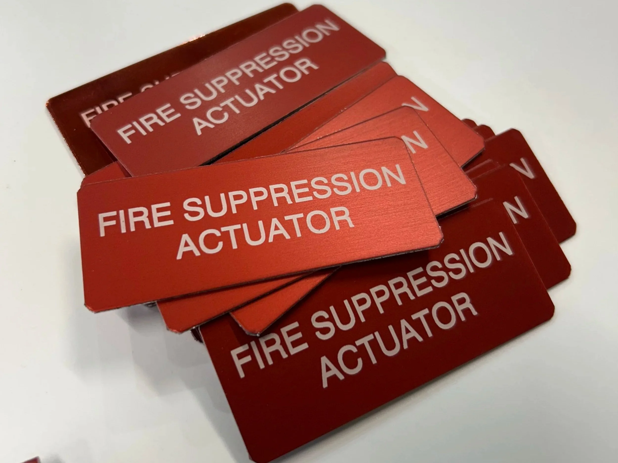 Multiple red fire suppression actuators stacked on top of each other.