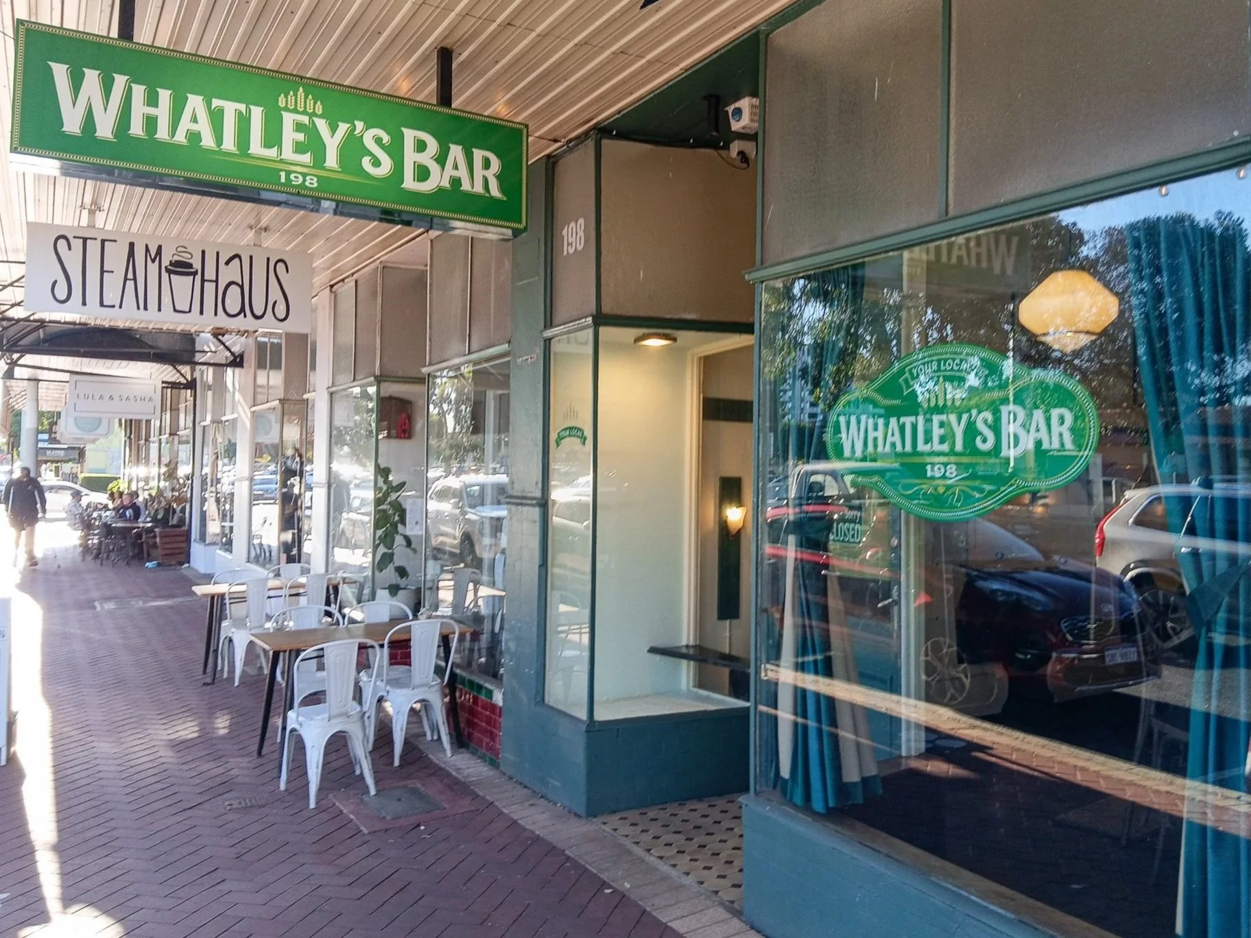 Street view of a storefront with signs for 'Whatley's Bar'. Lightbox Signage. Lightbox Business. Window Signage. Window Decal. Business Signage. Bar Signage. Pub Signage. Hospitality Signage. Commercial Signage. Perth Signage. Perth Business