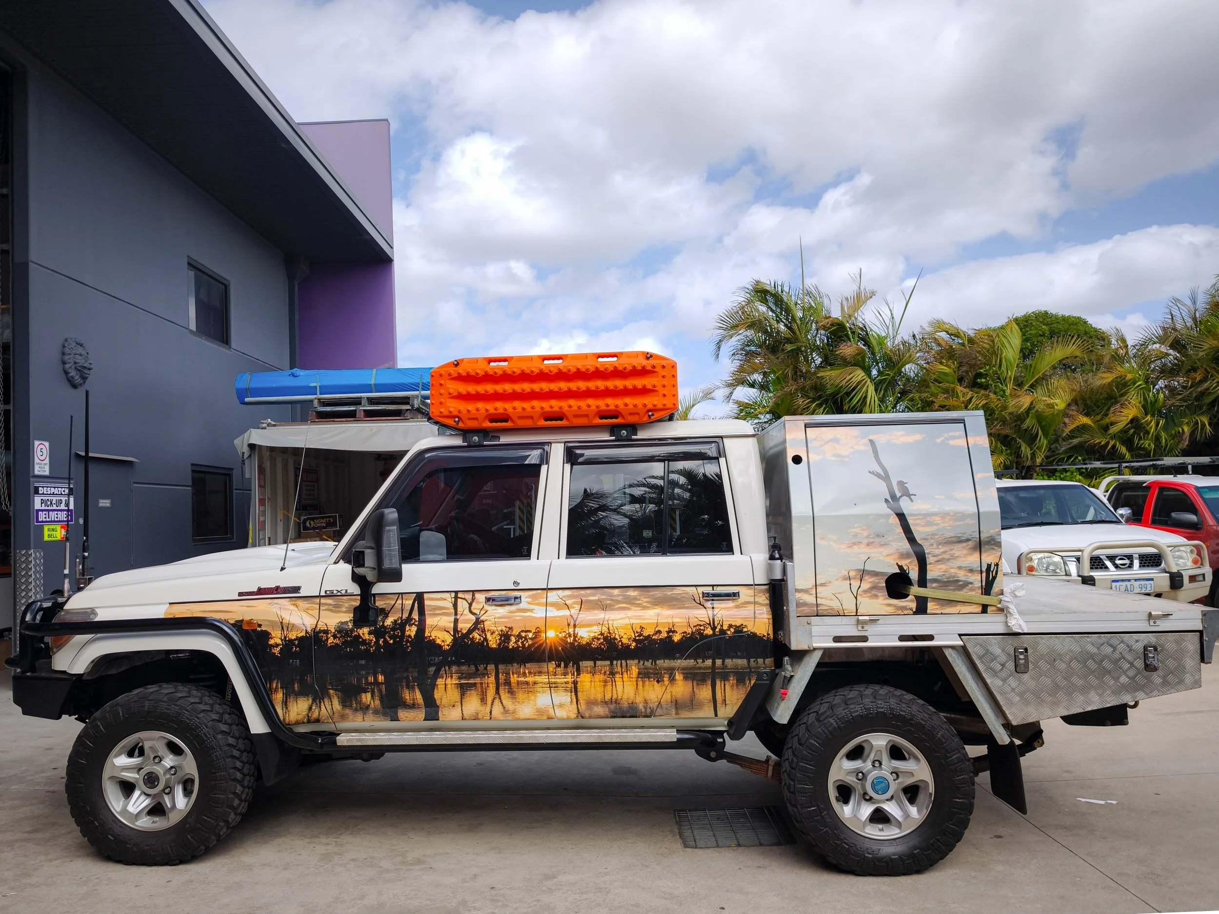 A white 79 Series Toyota Landcruiser ute with custom personalised wrap of nature. 4WD signage custom wrap