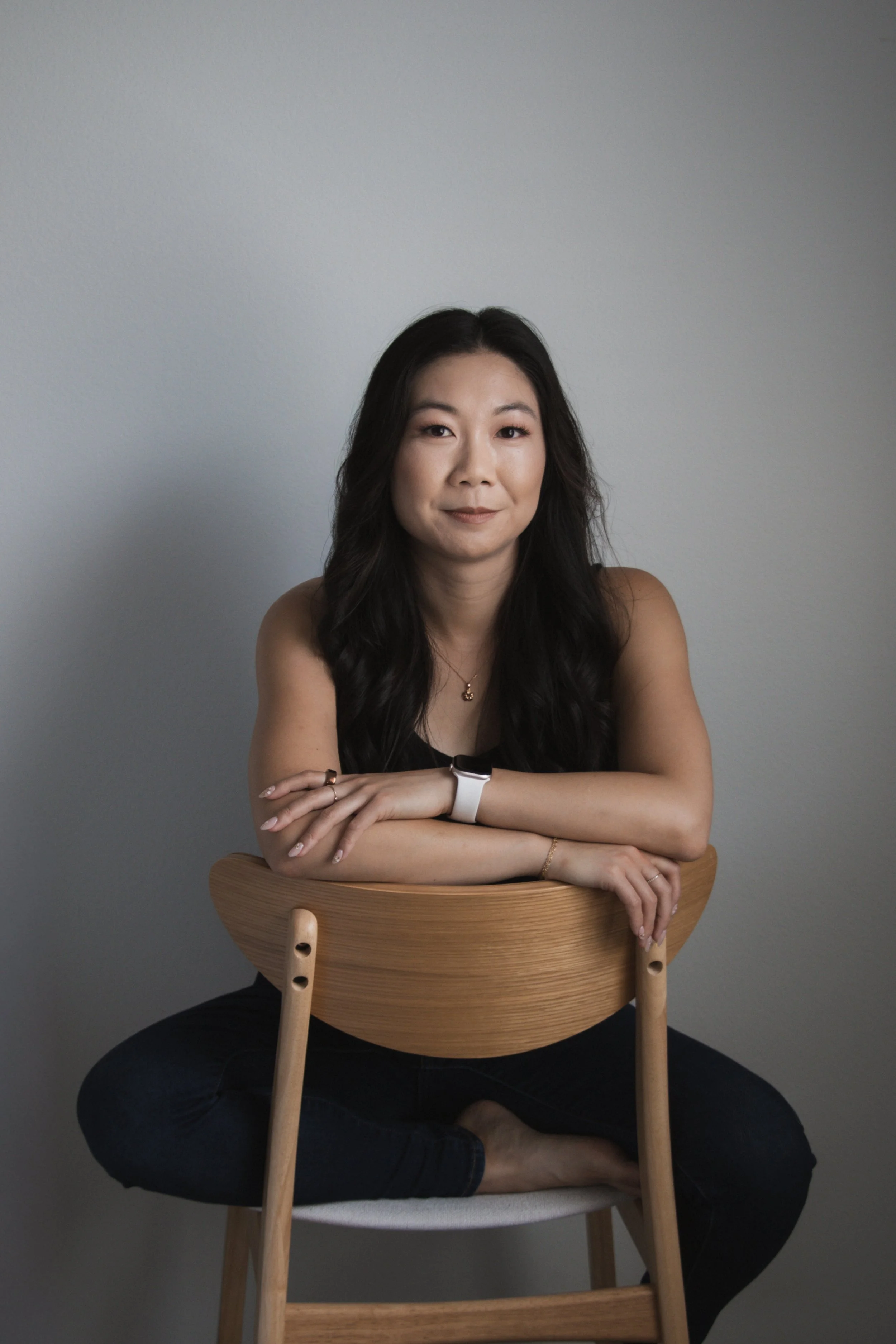 picture of girl sitting on a wood chair