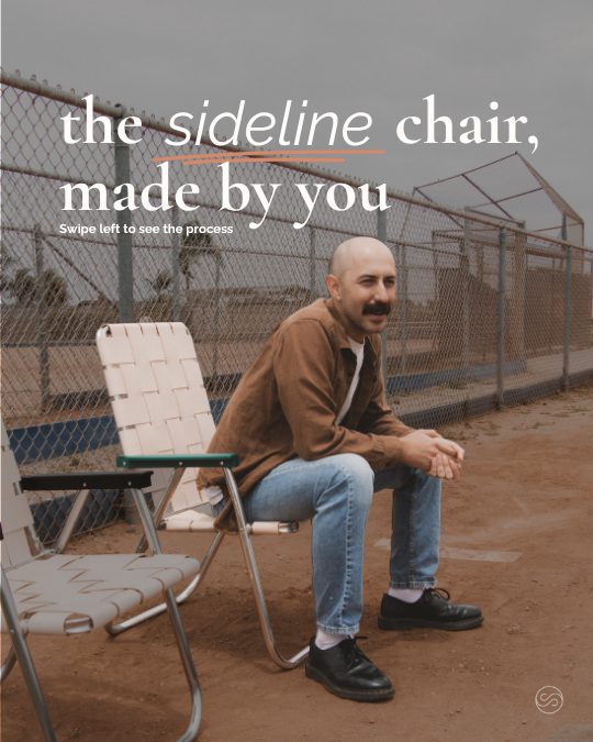 A man with a beard and mustache sitting on a metal chair on a dirt field, with another empty chair beside him, and a chain-link fence and cloudy sky in the background. Text on the image reads: "the sideline chair, made by you. Swipe left to see the process."