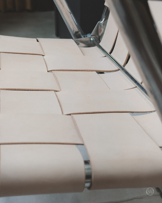 Close-up of cardboard boxes stacked on a metal surface, with metal framing and reflective surfaces visible.