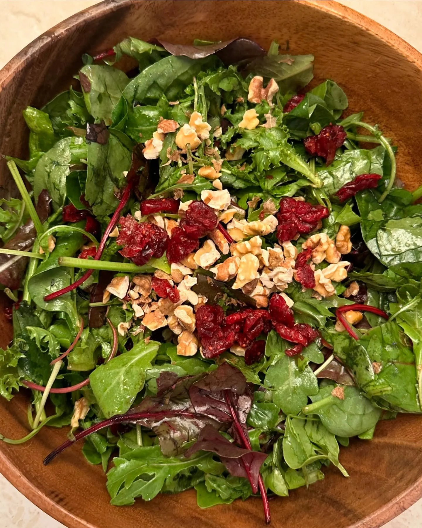 Mesclun salad tossed with walnuts, cranberries, and drizzled with a touch of balsamic vinegar and lemon zest olive oil. 🍋🥜