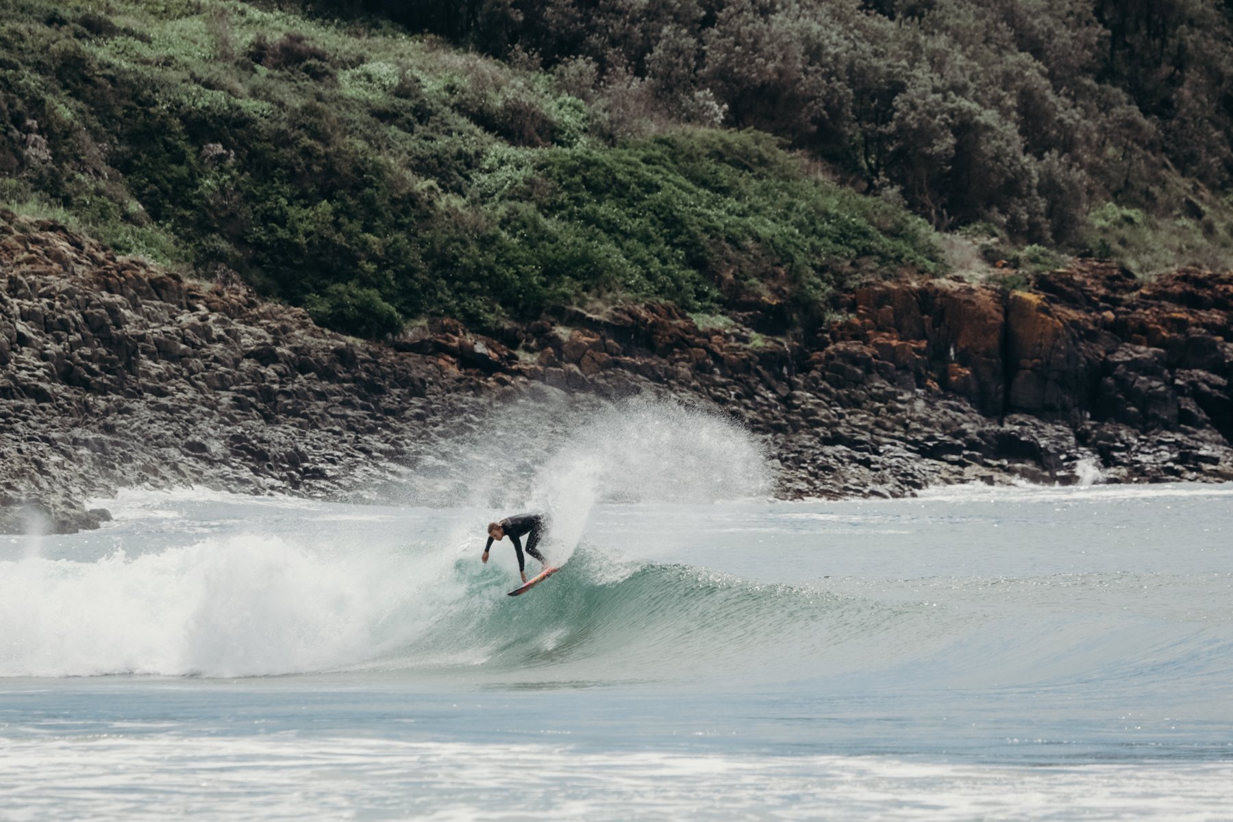 Sam Ayton, Shortie Surfboard custom surfboard shaper, surfing down the coast during an R&D session, doing a backside top turn.