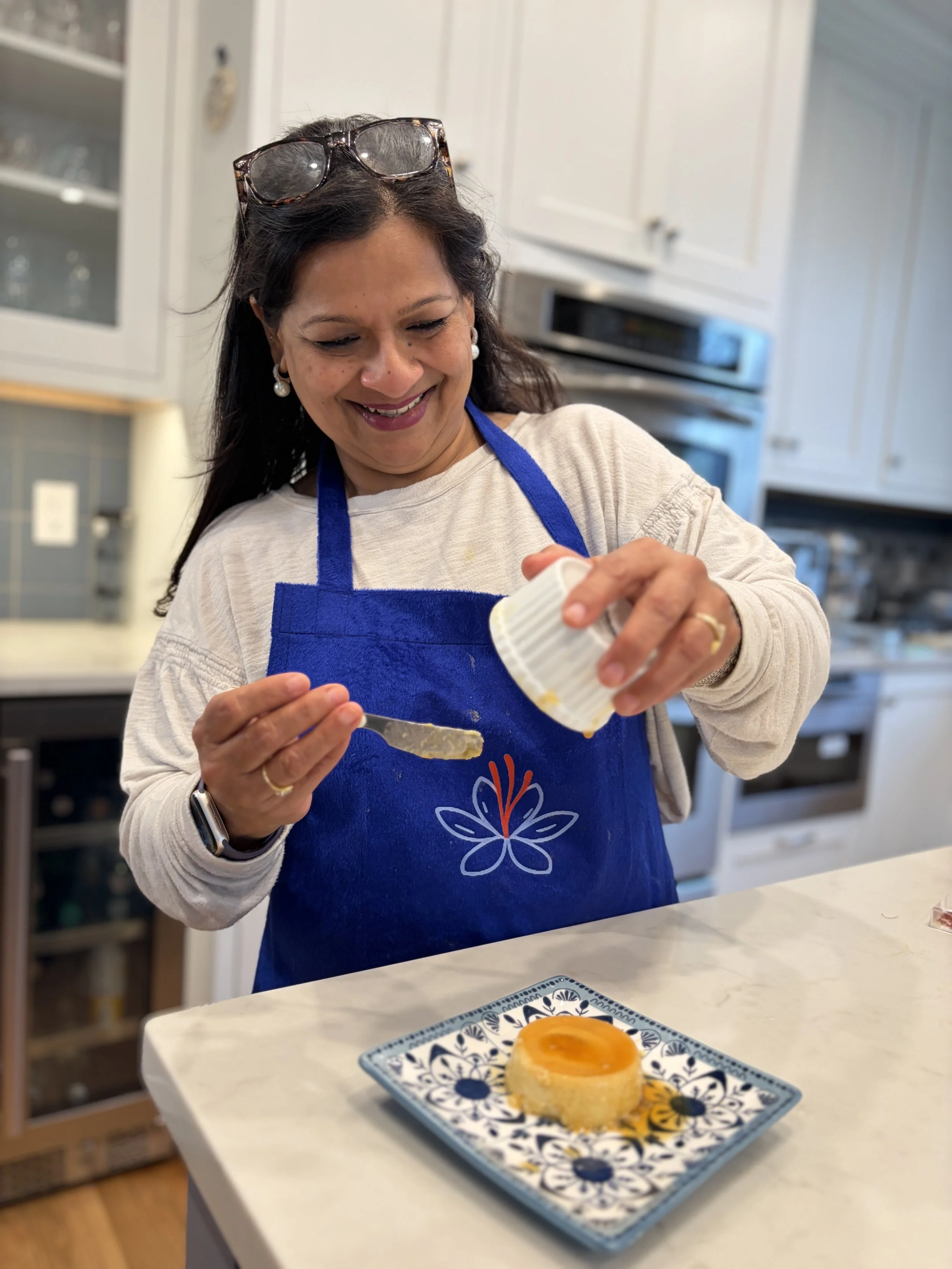 Chef Sarita Bhagwat plating a handcrafted dessert in her home kitchen during a private chef experience in Arlington, Massachusetts.