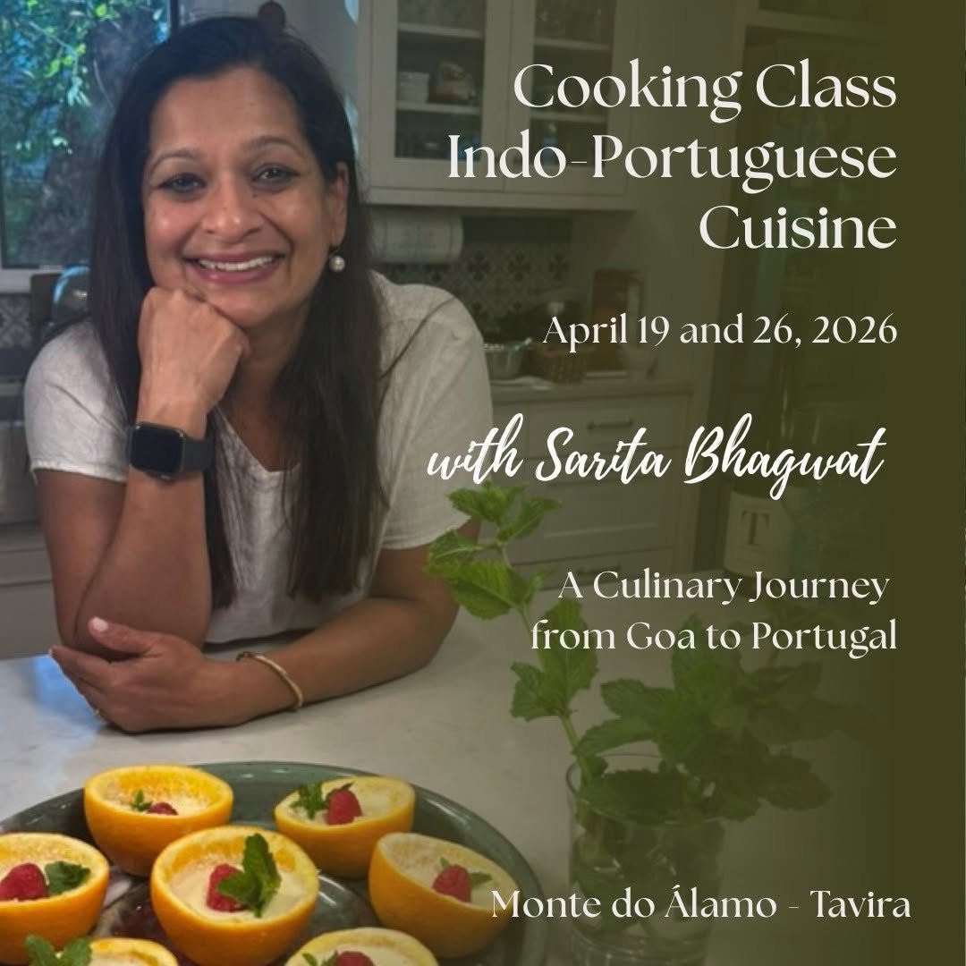 Smiling woman in a kitchen with citrus bowls decorated with herbs and berries on the table, promoting a cooking class on Indo-Portuguese cuisine.